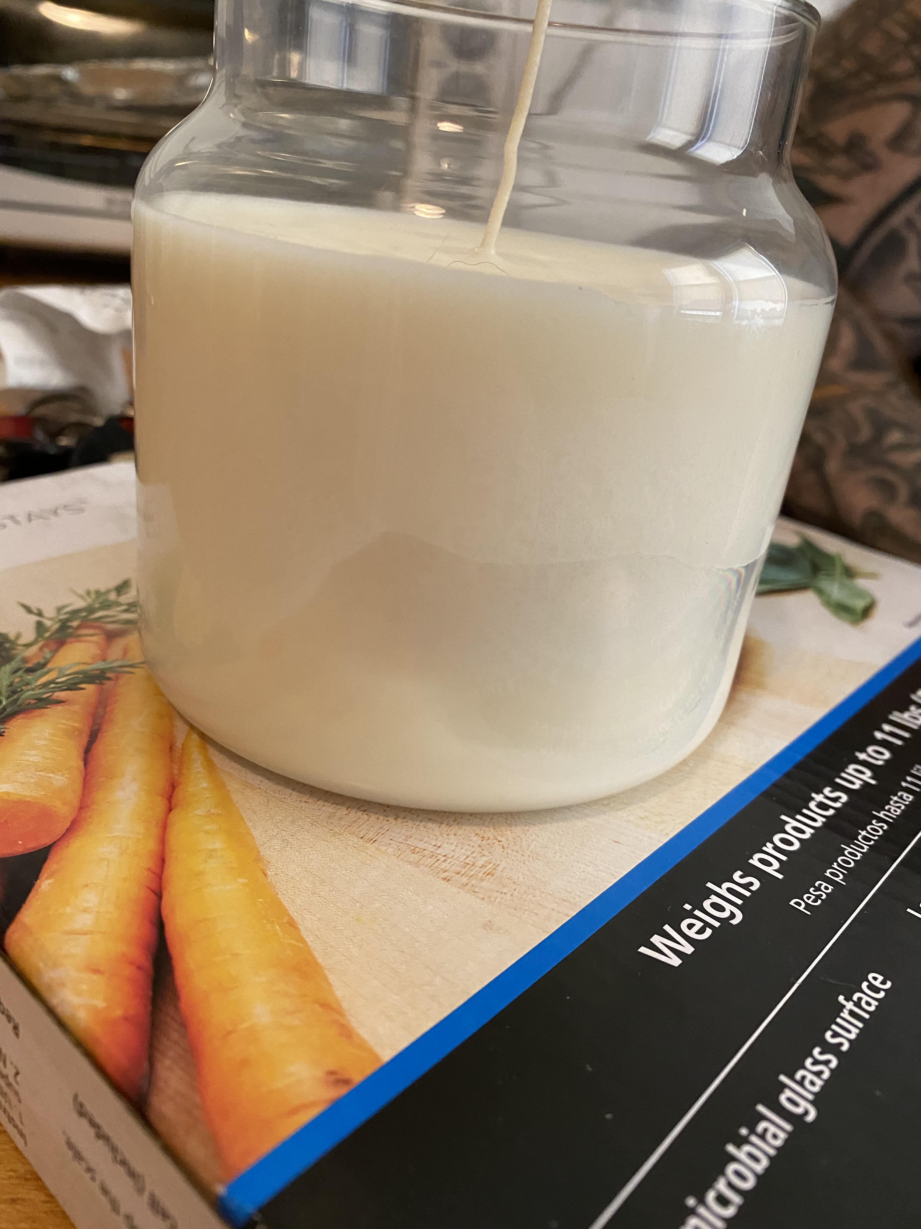 First candle I’ve ever made. Any ideas what is happening on the side here or how to fix it? r