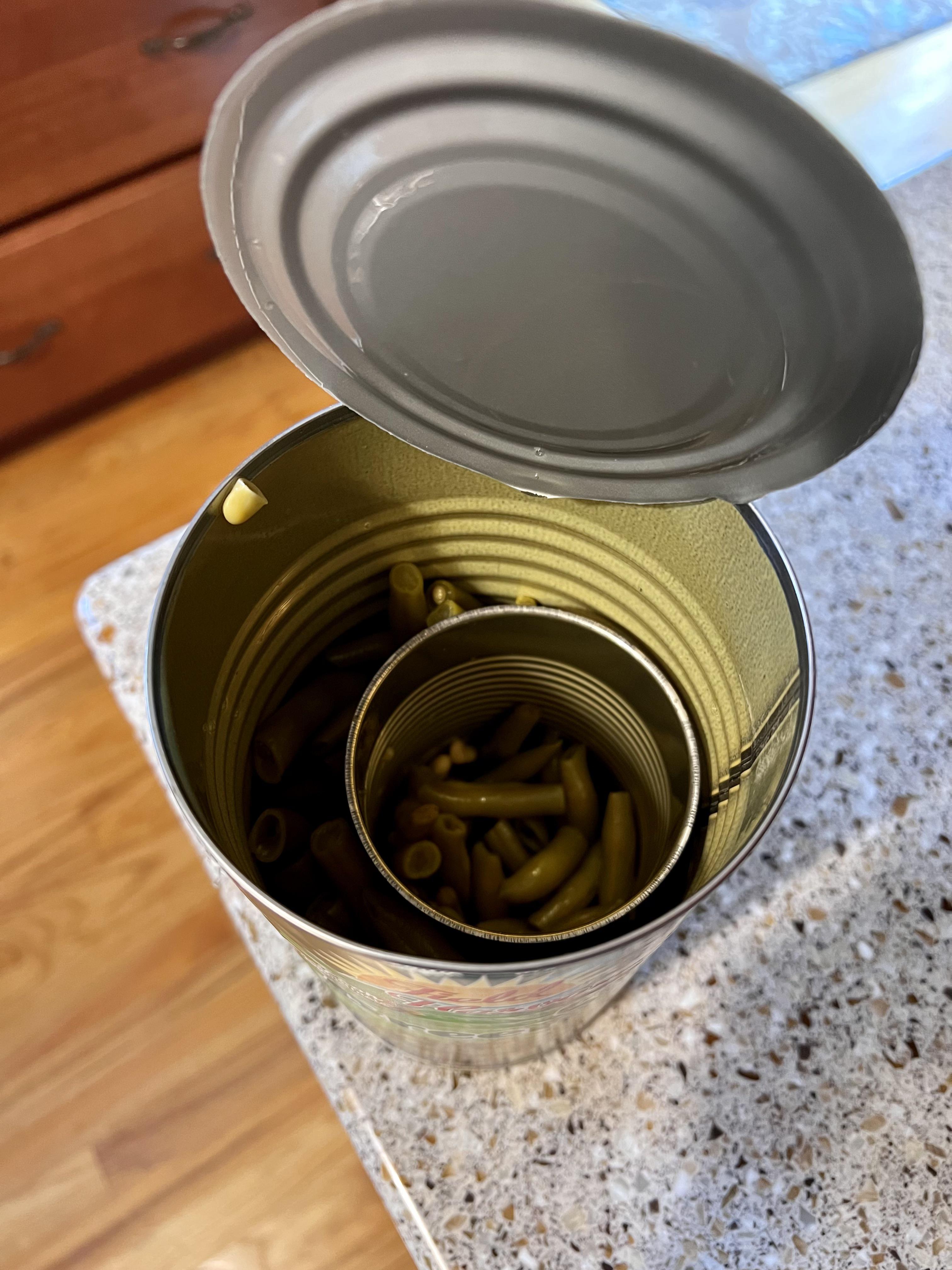 A can of green beans sealed into a larger can of green beans. How does