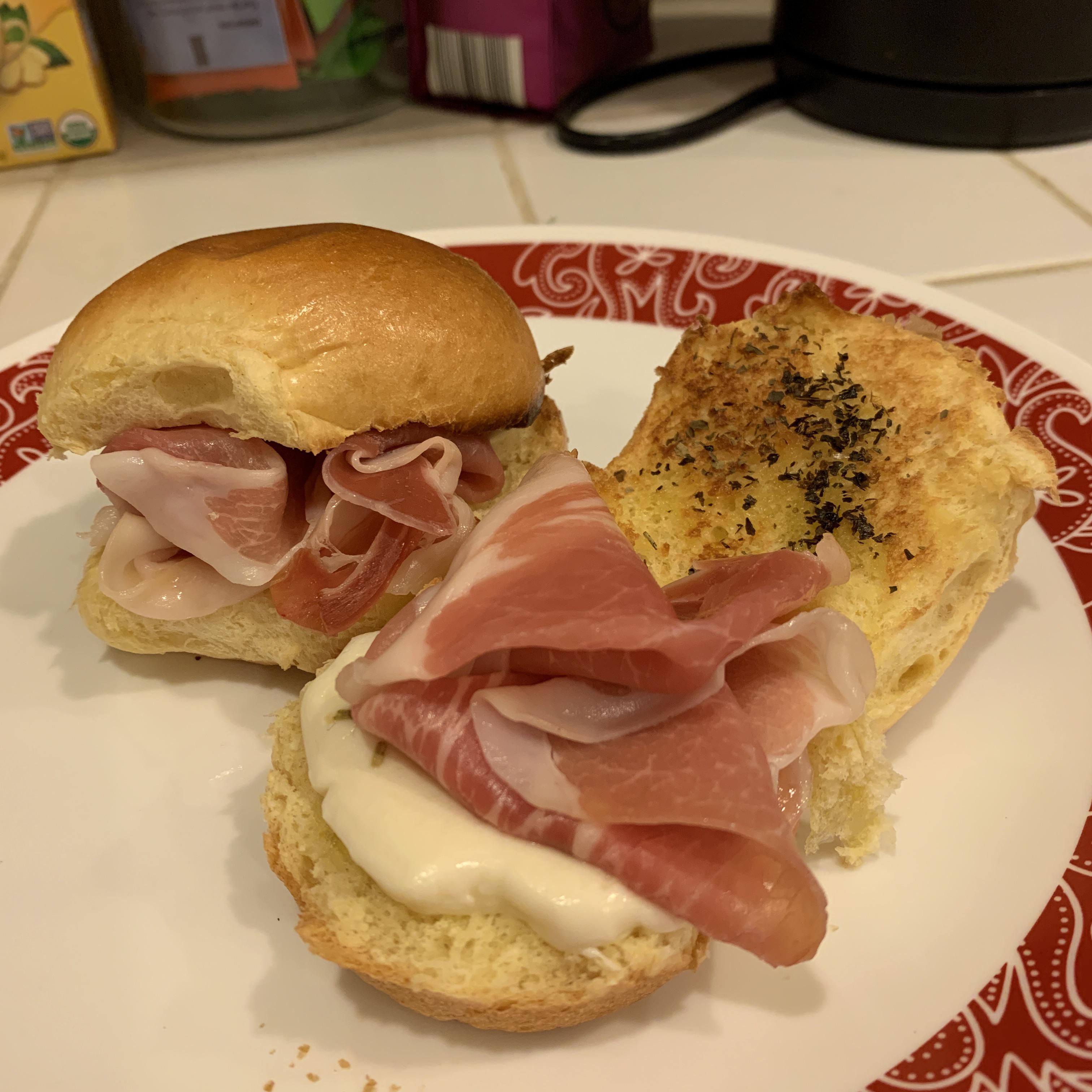 Mozzarella and prosciutto on a toasted brioche bun, with olive oil