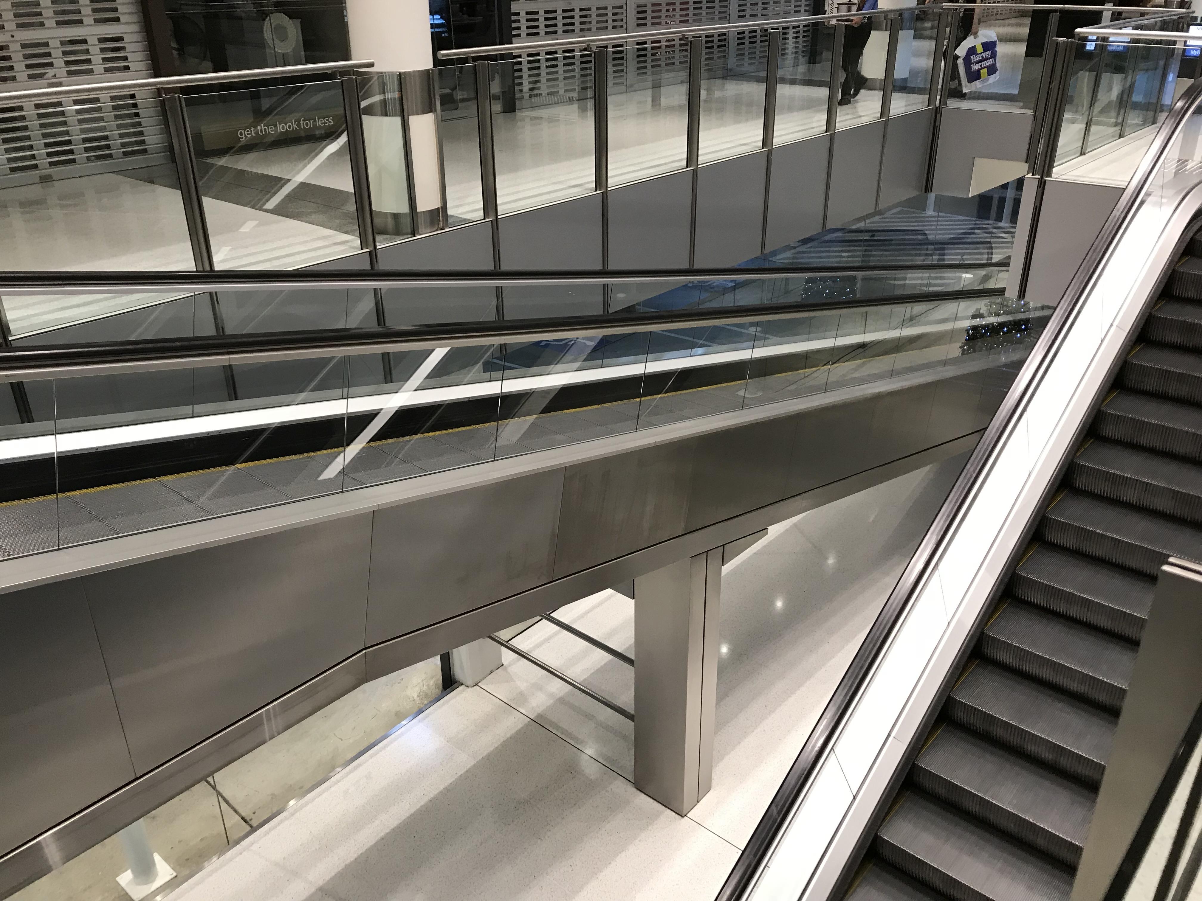 This shopping mall has an escalator up and a travelator down for people