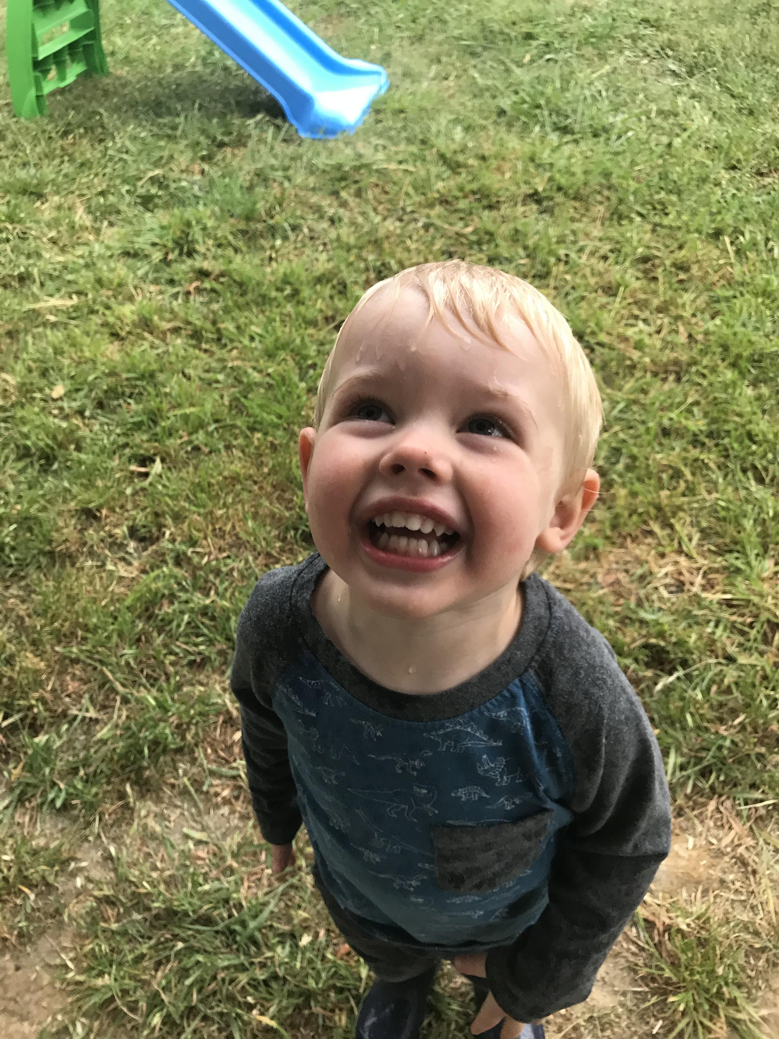 My son playing in the rain for the first time. Are toddlers still