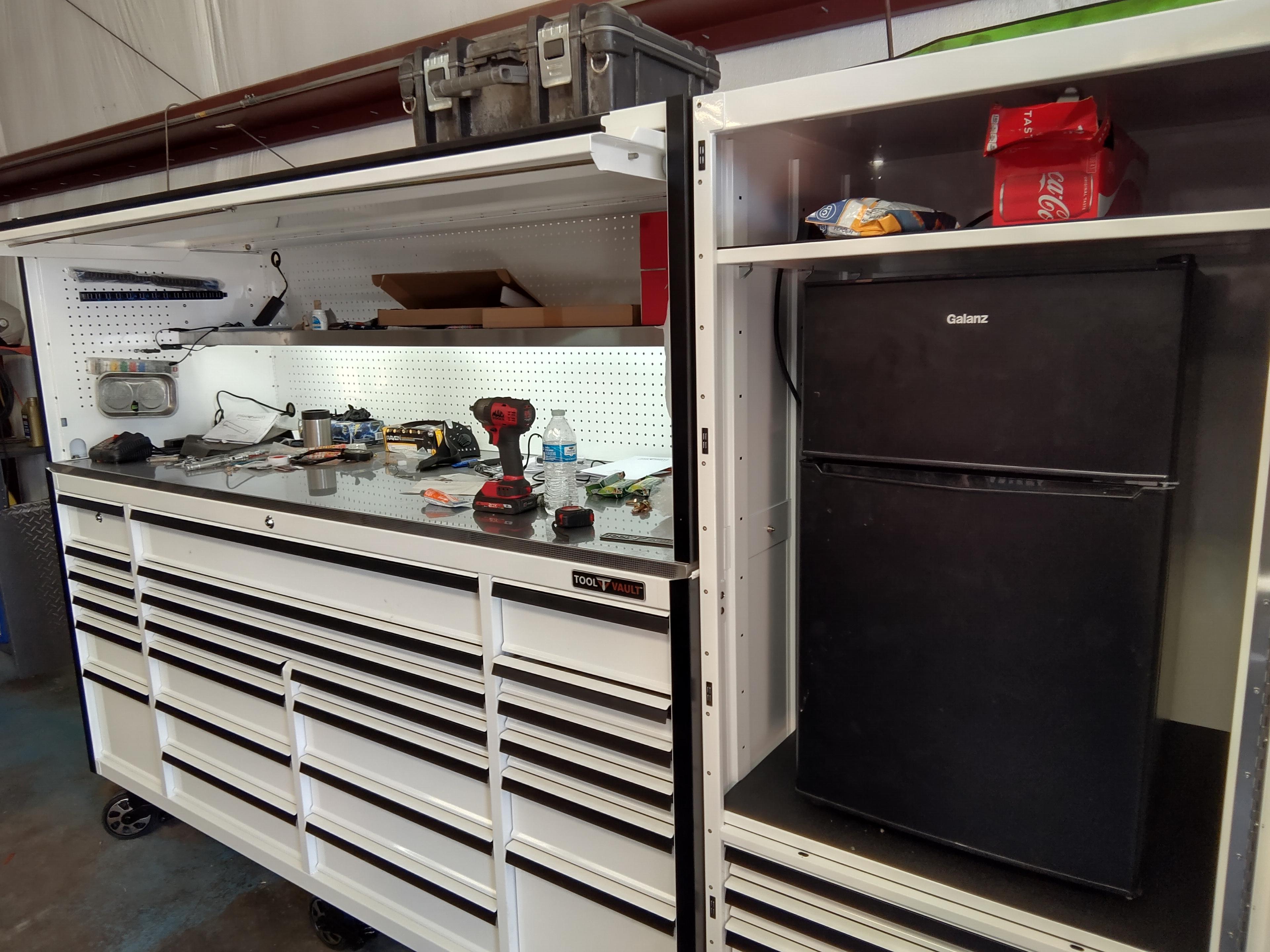 Installed mini fridge and lighting over worktop.