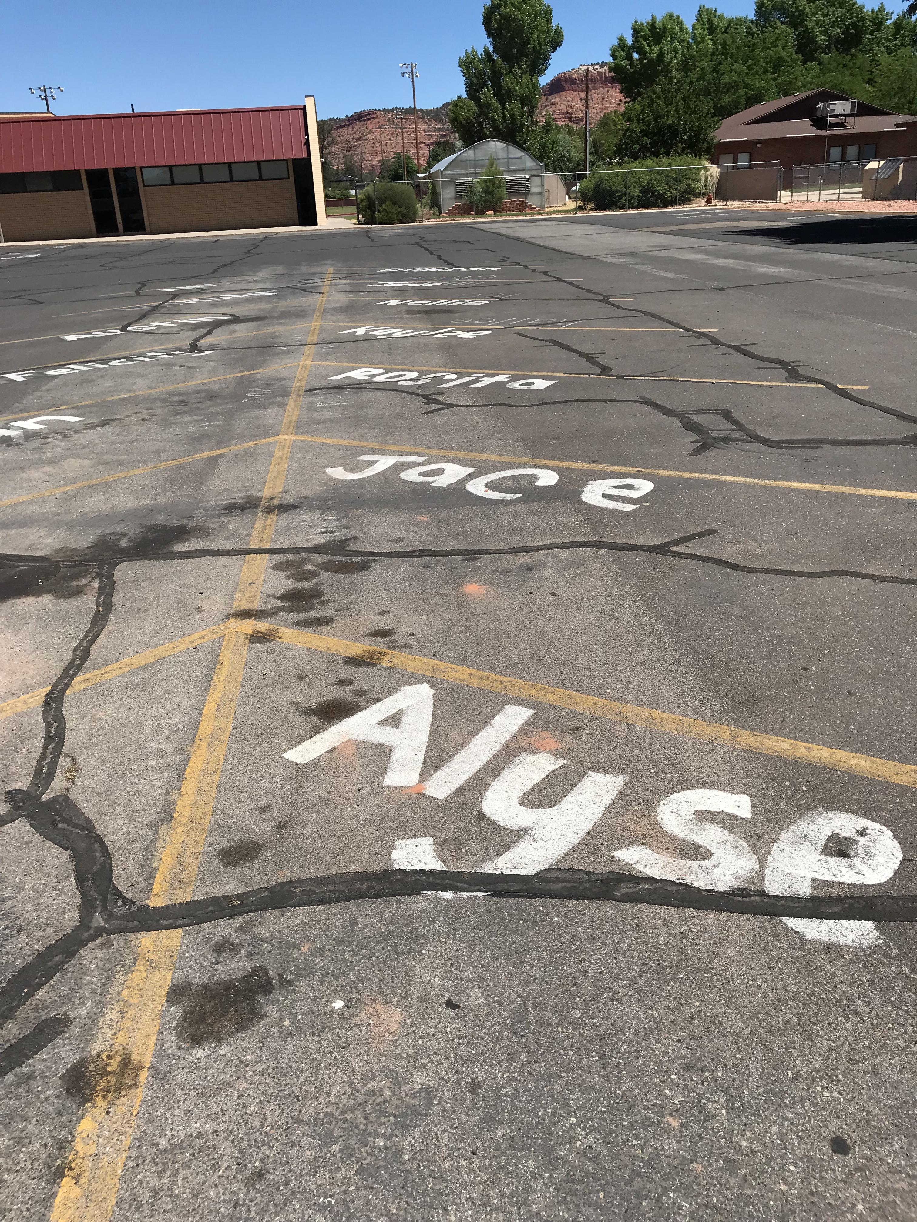 The parking spaces in this parking lot at a high school in Utah have