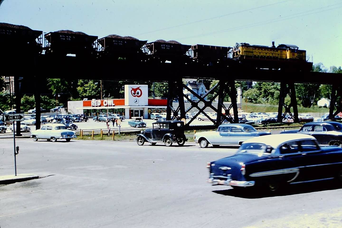 Ore train passing the Red Owl market in Marquette, Michigan. 1950s