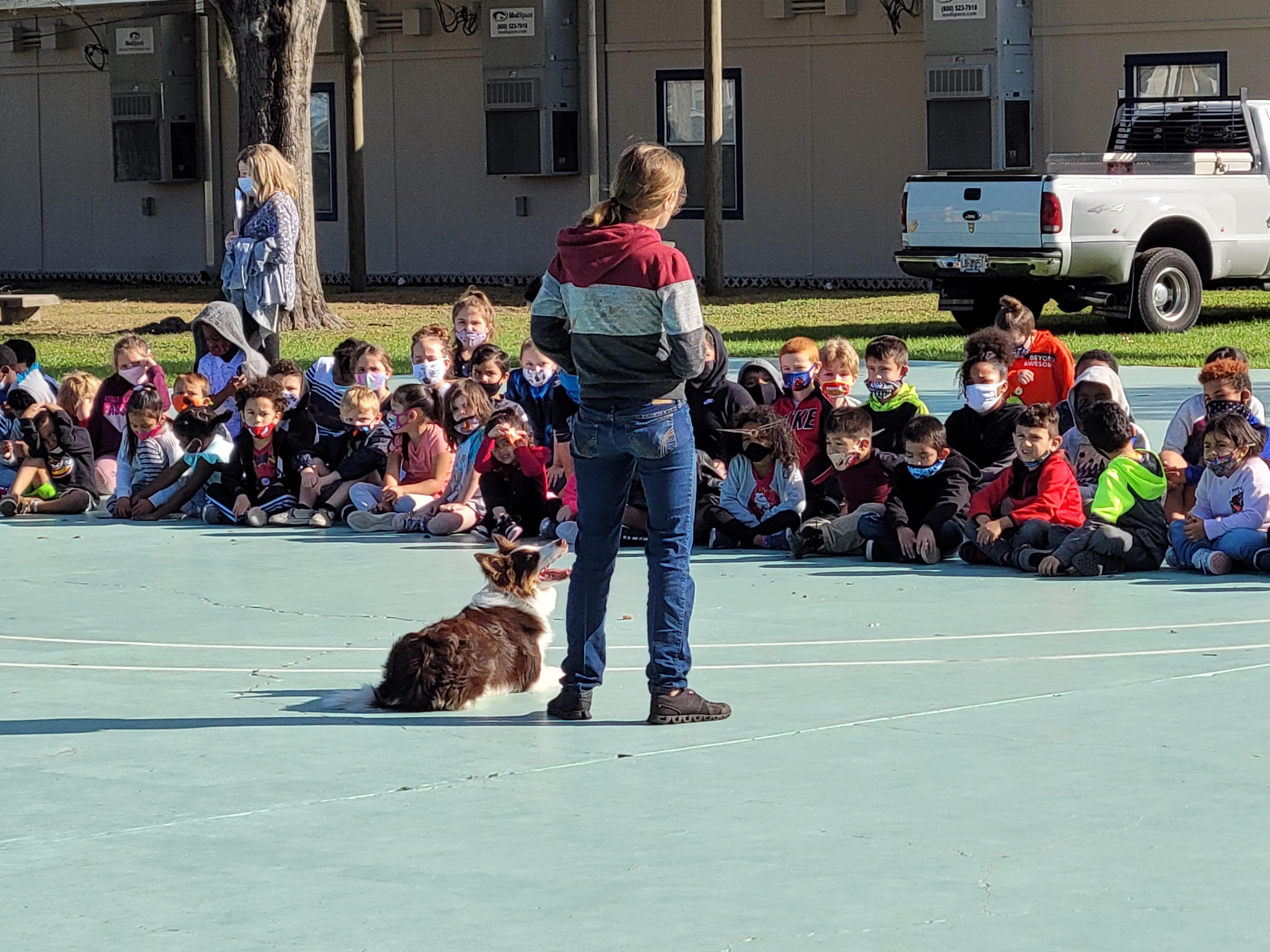 Ohana Dog Training's Cassie Kennedy giving a demonstration for the children at Lopez Elementary
