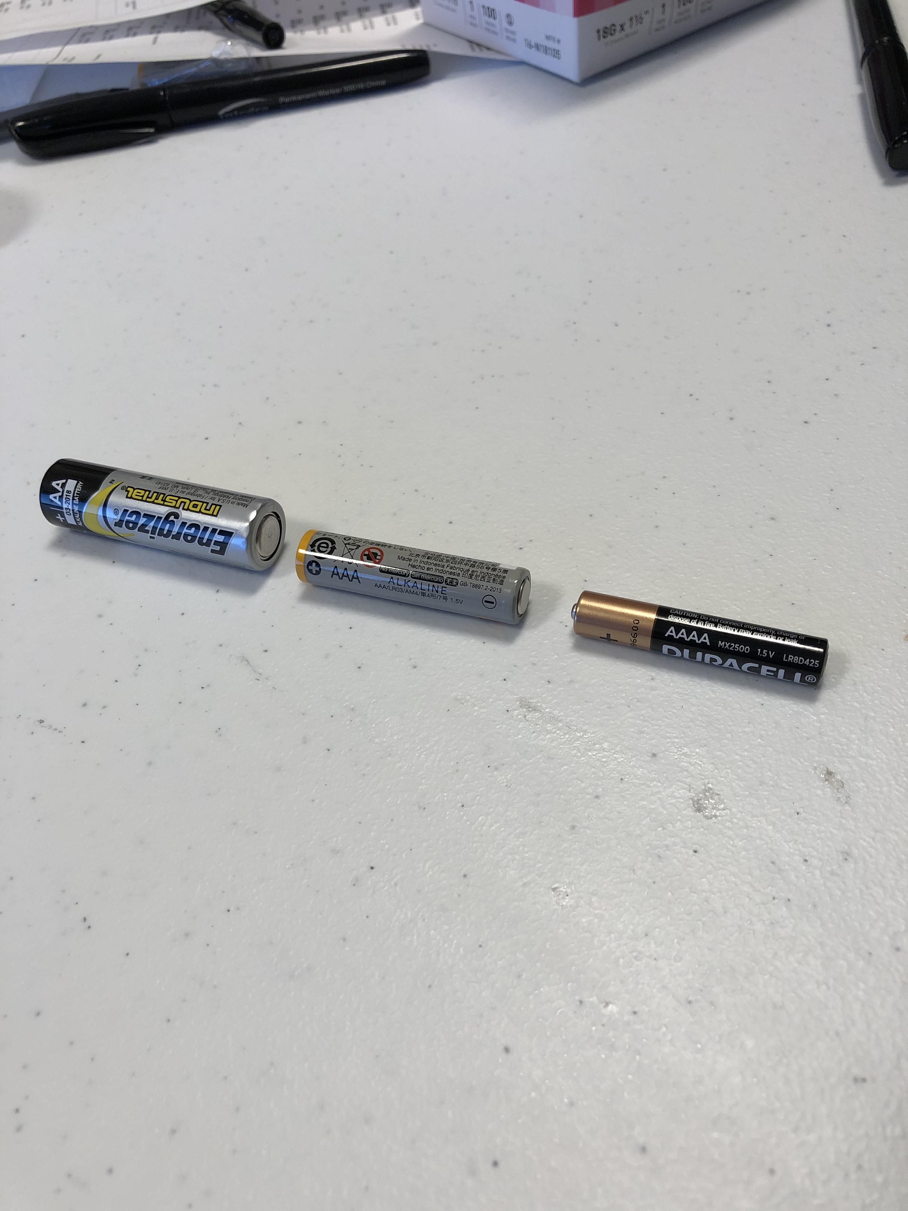 AAAA battery next to a AA and AAA. mildlyinteresting