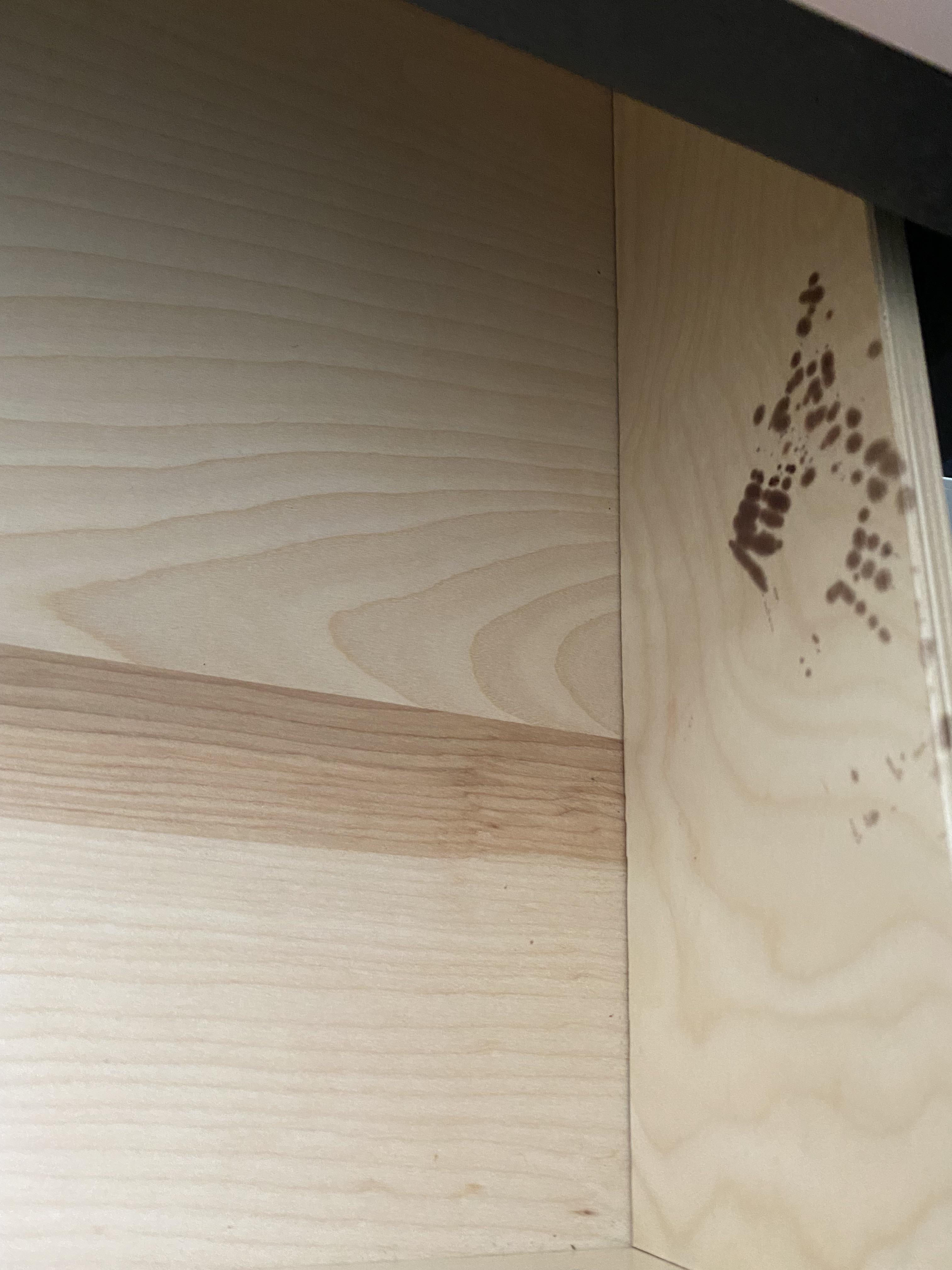 Any idea what this is / how to clean? Black spots in dresser drawer. Details in comment. r