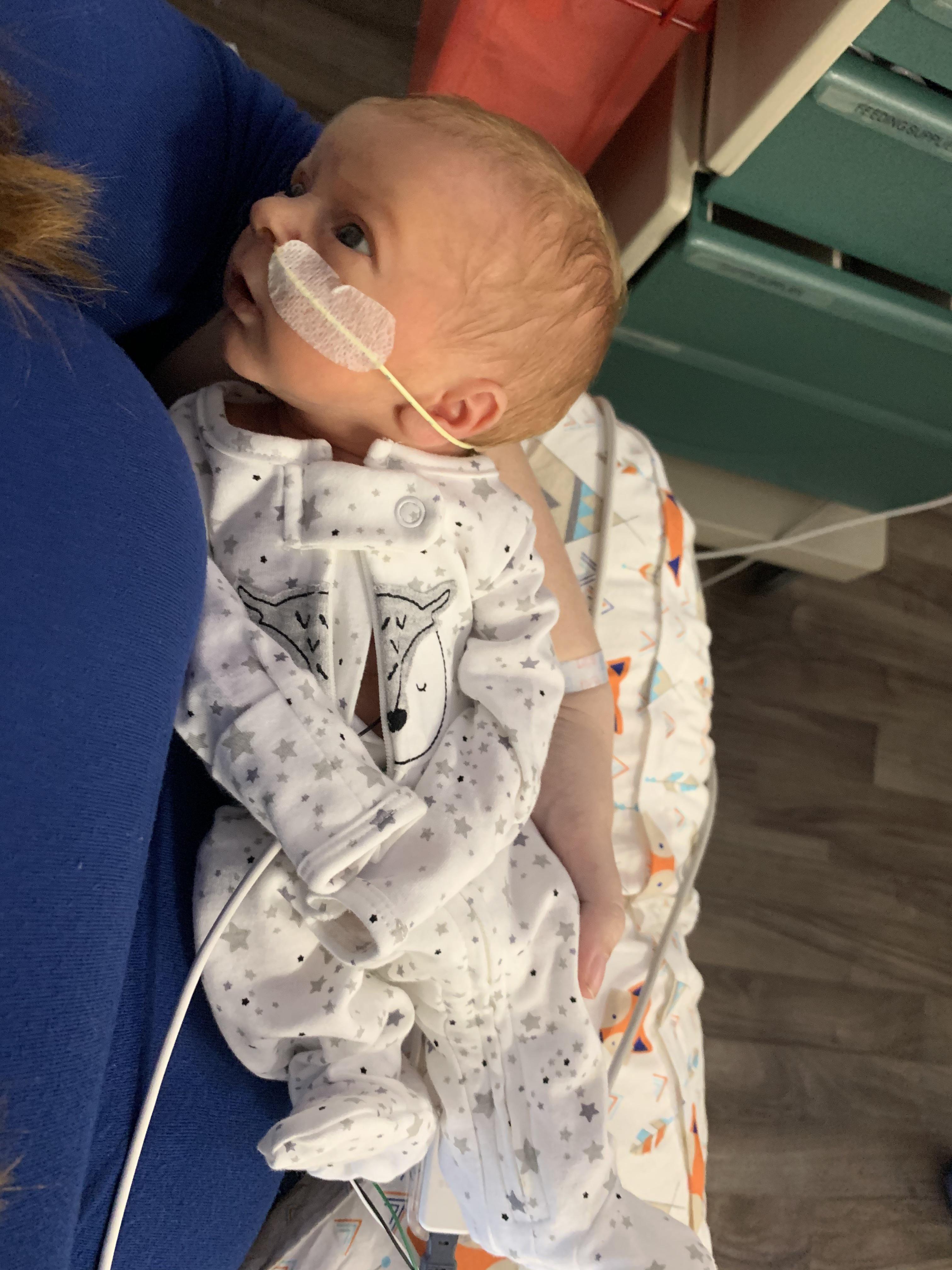 My son mirin me in the NICU, one week old and his first time wearing