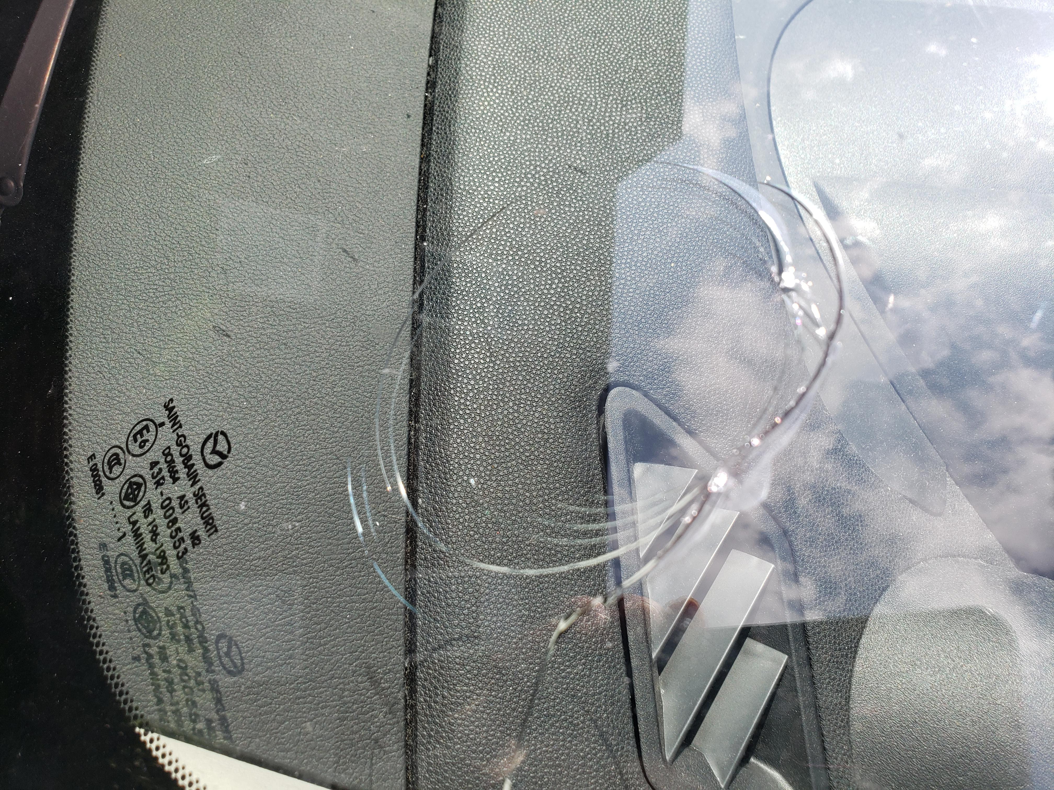 A rock from a passing dump truck just cracked my windshield r