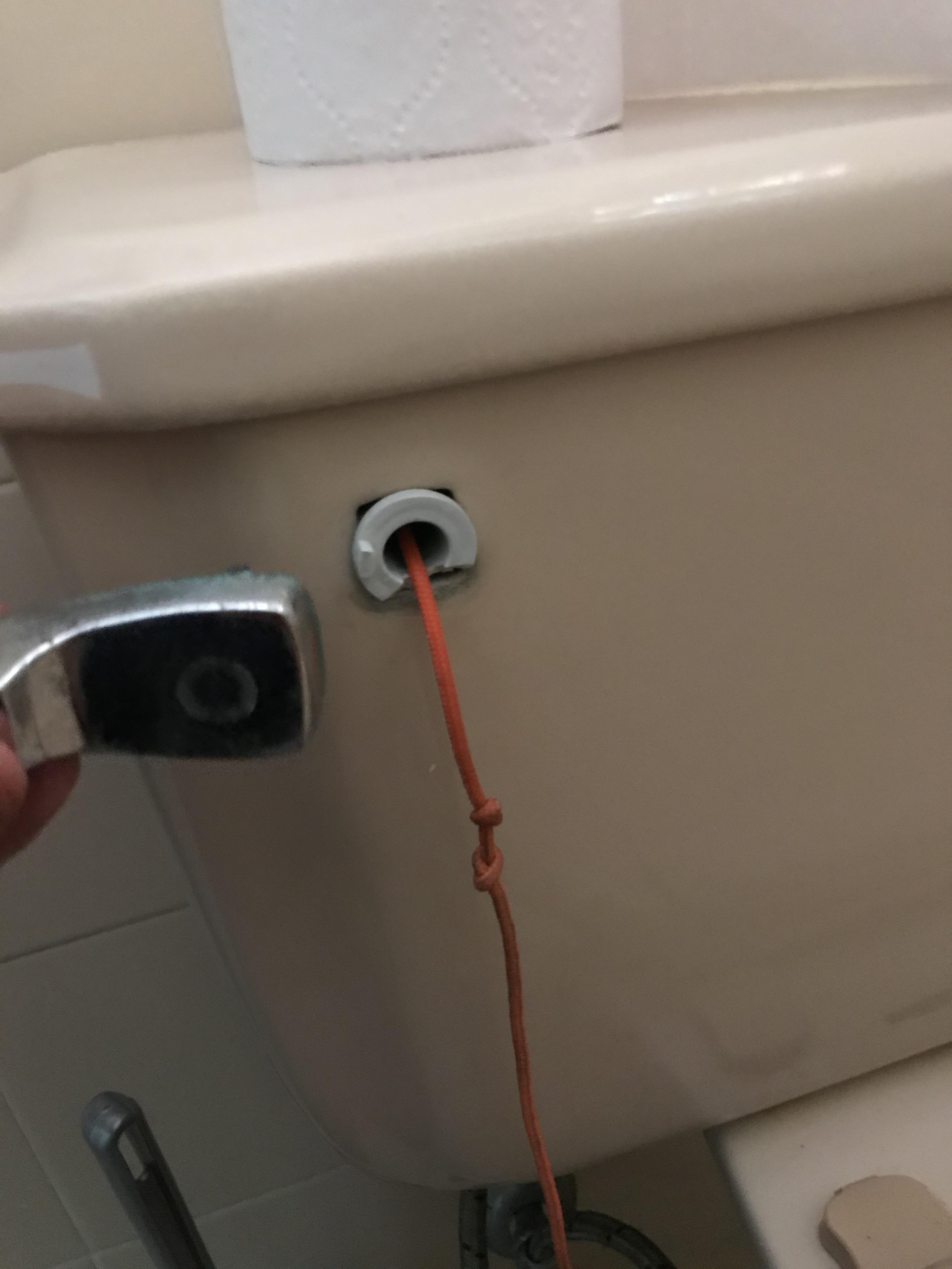 The handle to flush the toilet in our house broke, so we fixed it using a piece of string. r