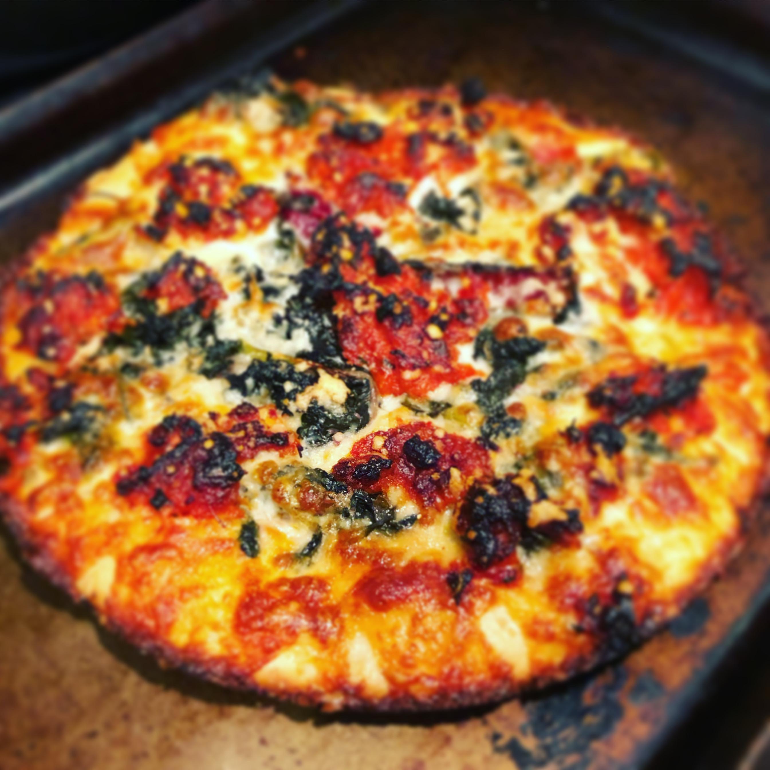 “Detroit “style cast iron pizza with tomato pesto and braised greens