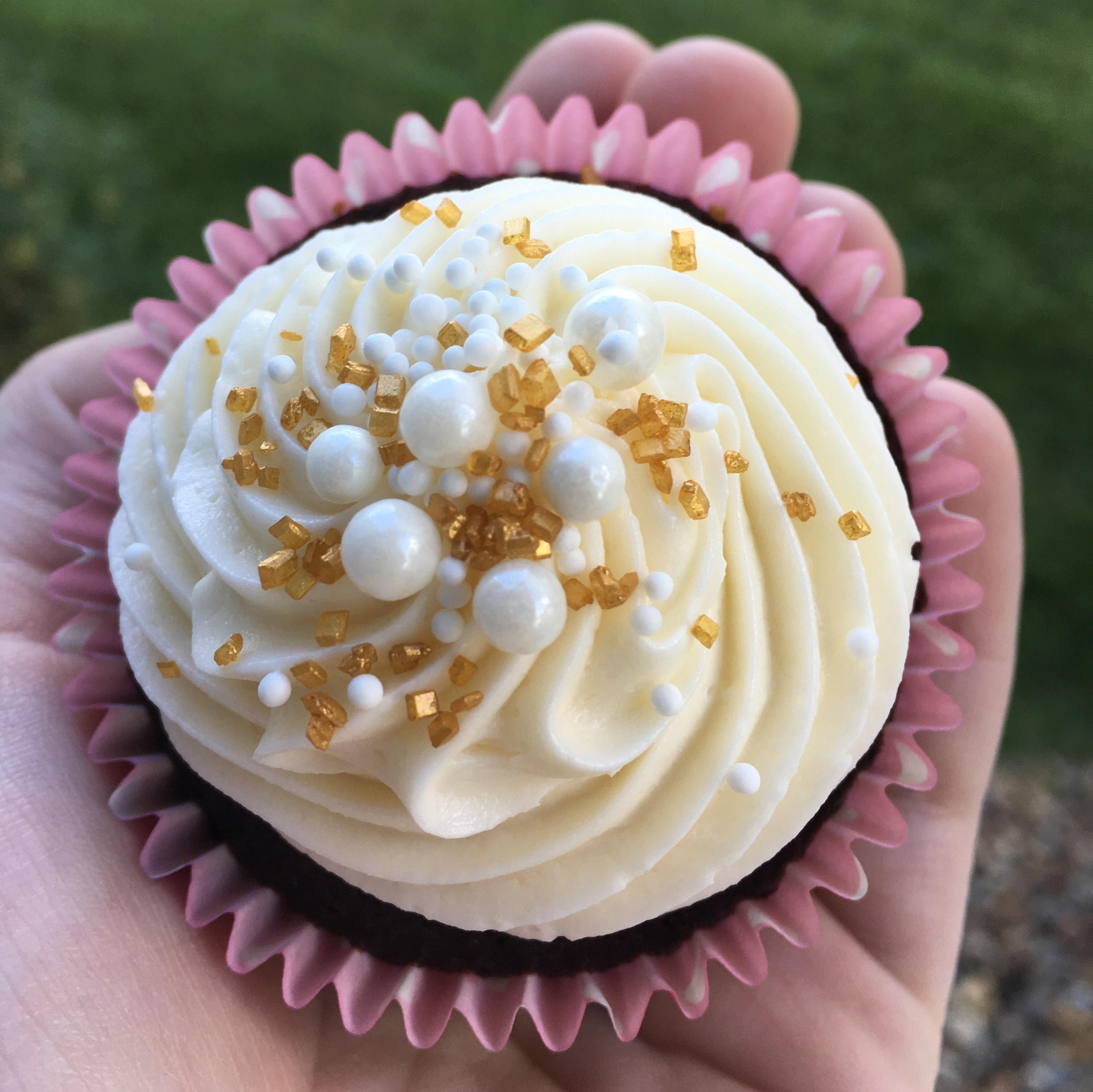 Chocolate cupcakes with buttercream topped with edible pearls, white