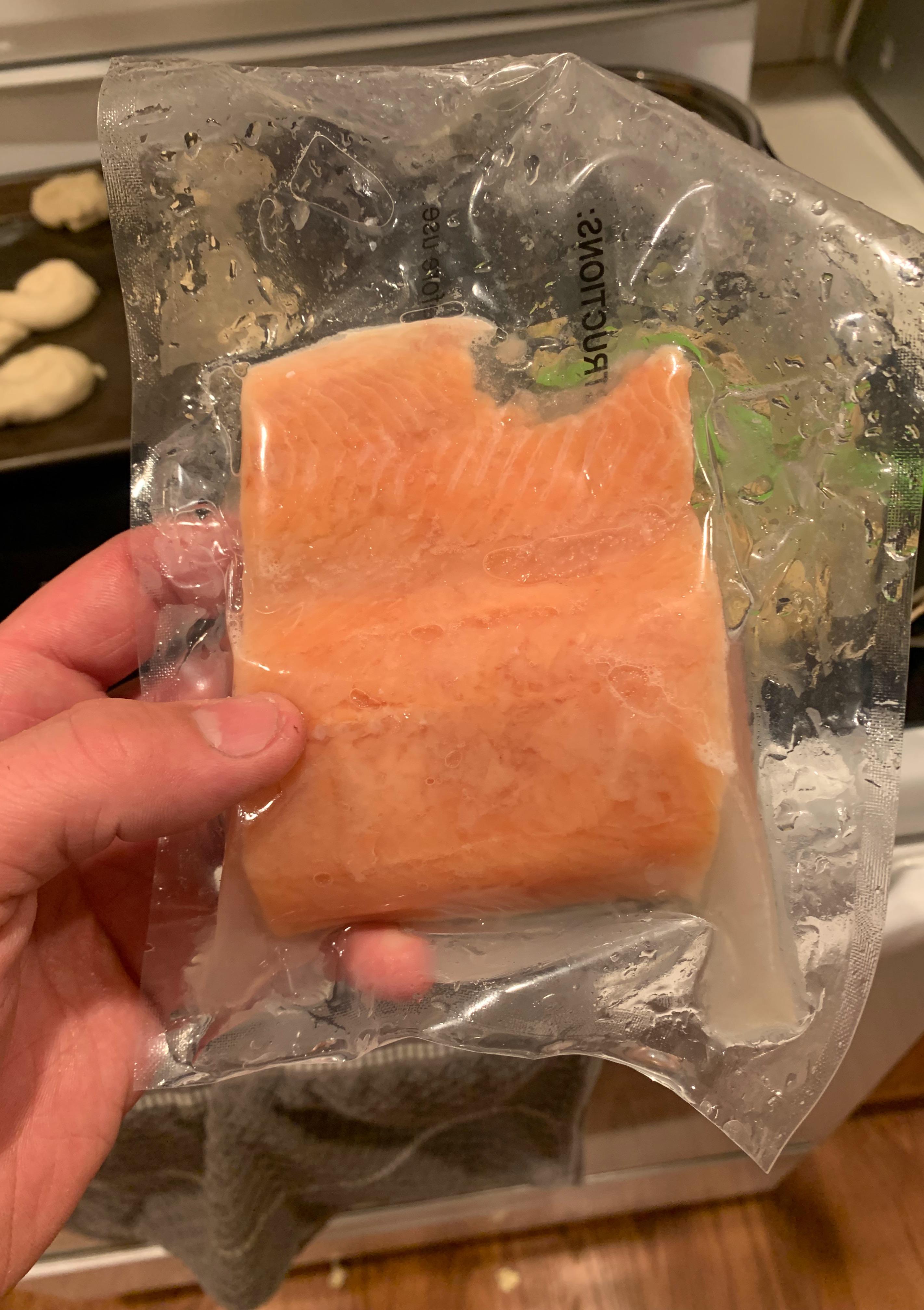 Vacuum sealed frozen salmon looks like someone took a bite out once