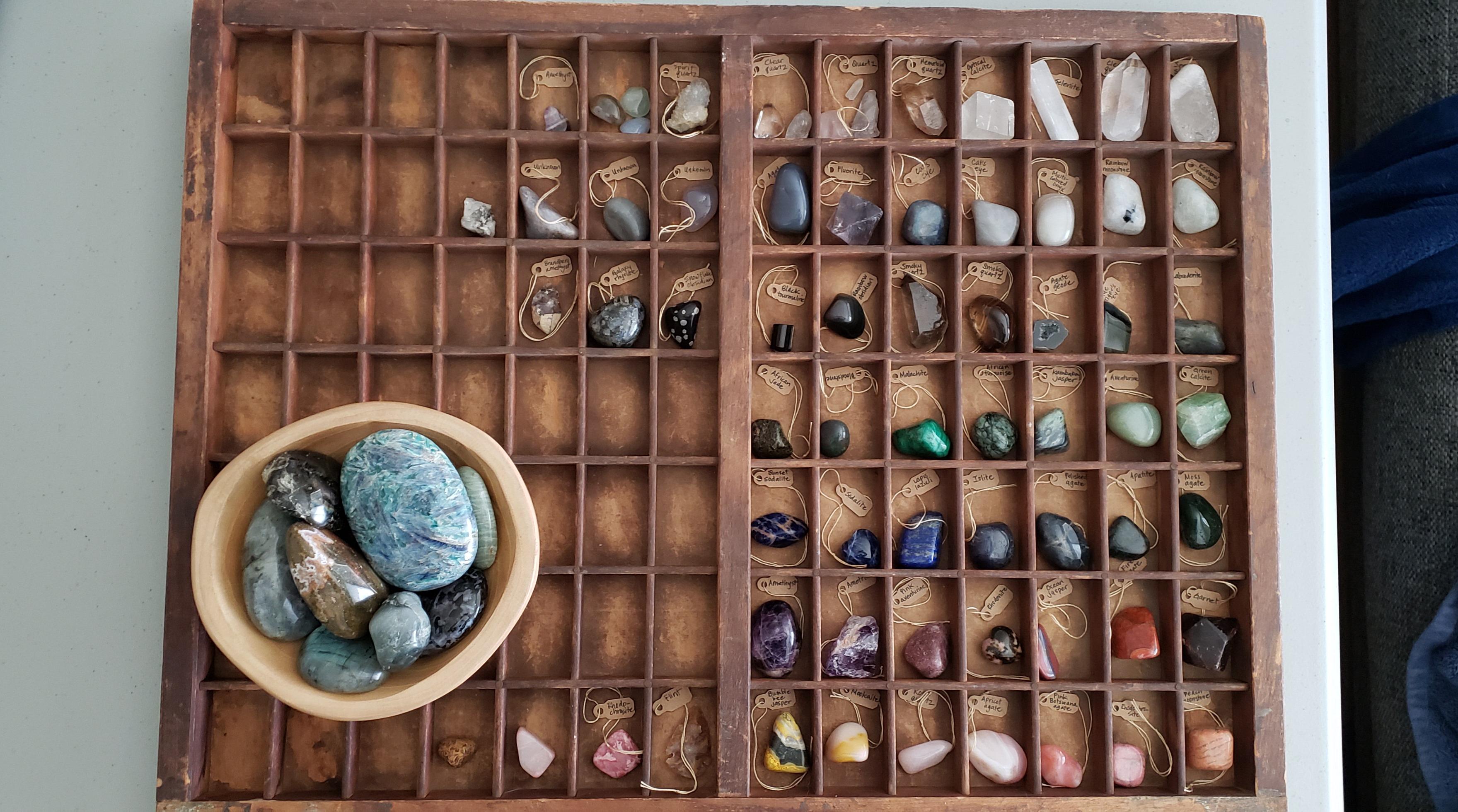 My smaller crystals in a vintage letterpress tray and my palm stones in