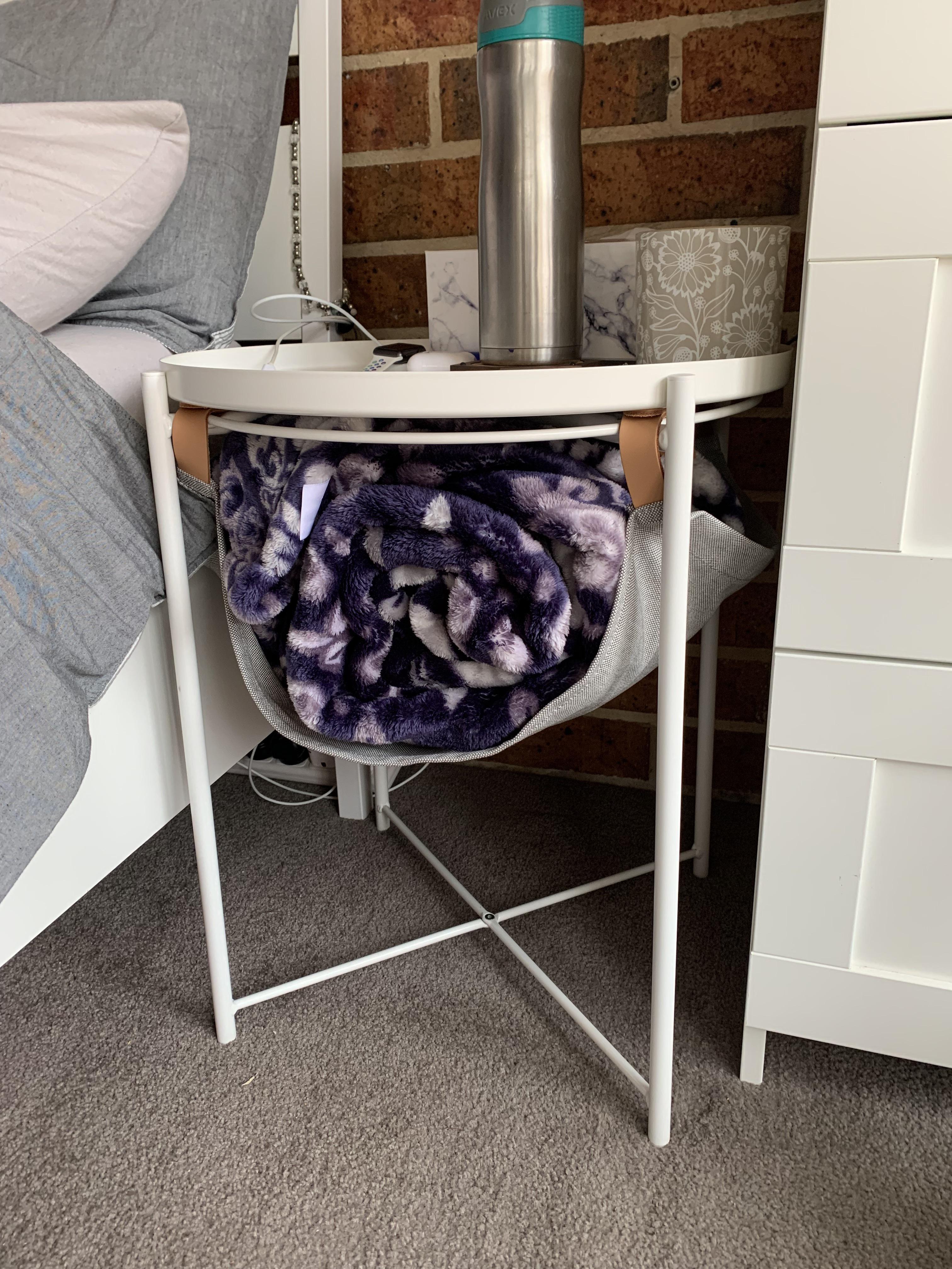 Can someone help me identify the blanket holder underneath the side table? I bought it years ago