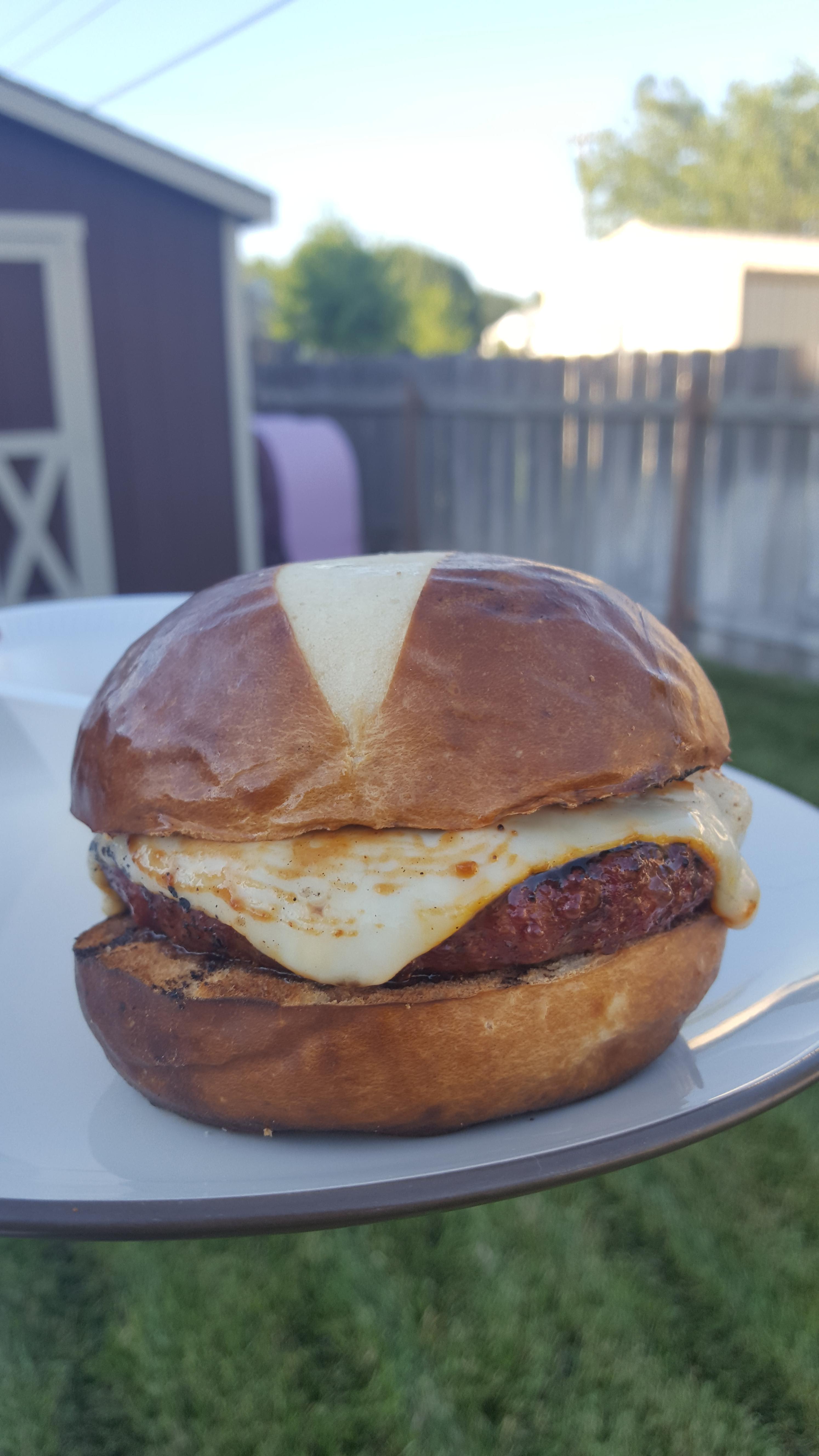 Smoked burger with muenster on pretzel bun. r/burgers