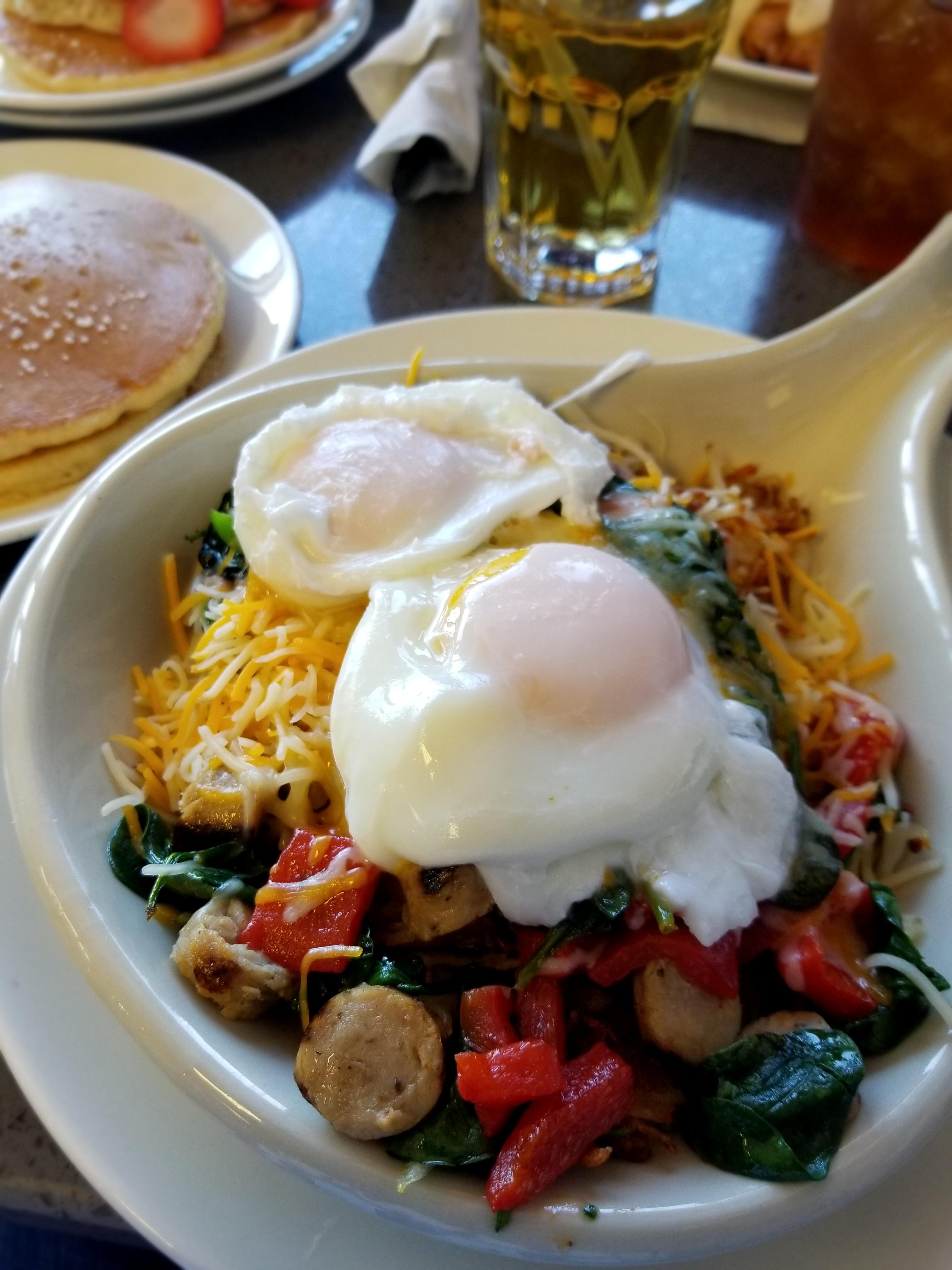 The Elm Skillet hashbrown skillet with poached eggs, bell peppers