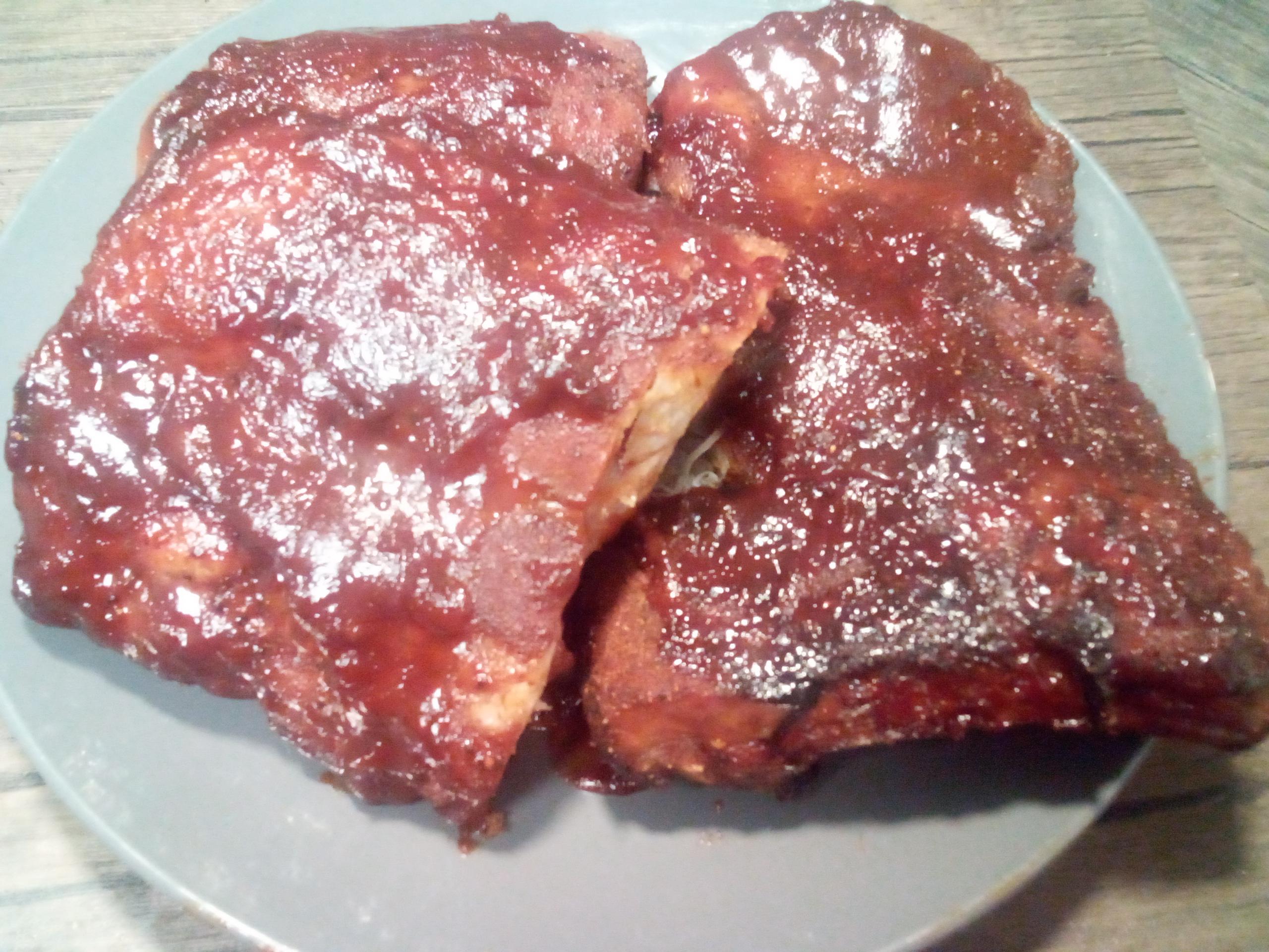 Baby back pork ribs, oven roasted in dry rub & sauce on top r/meat