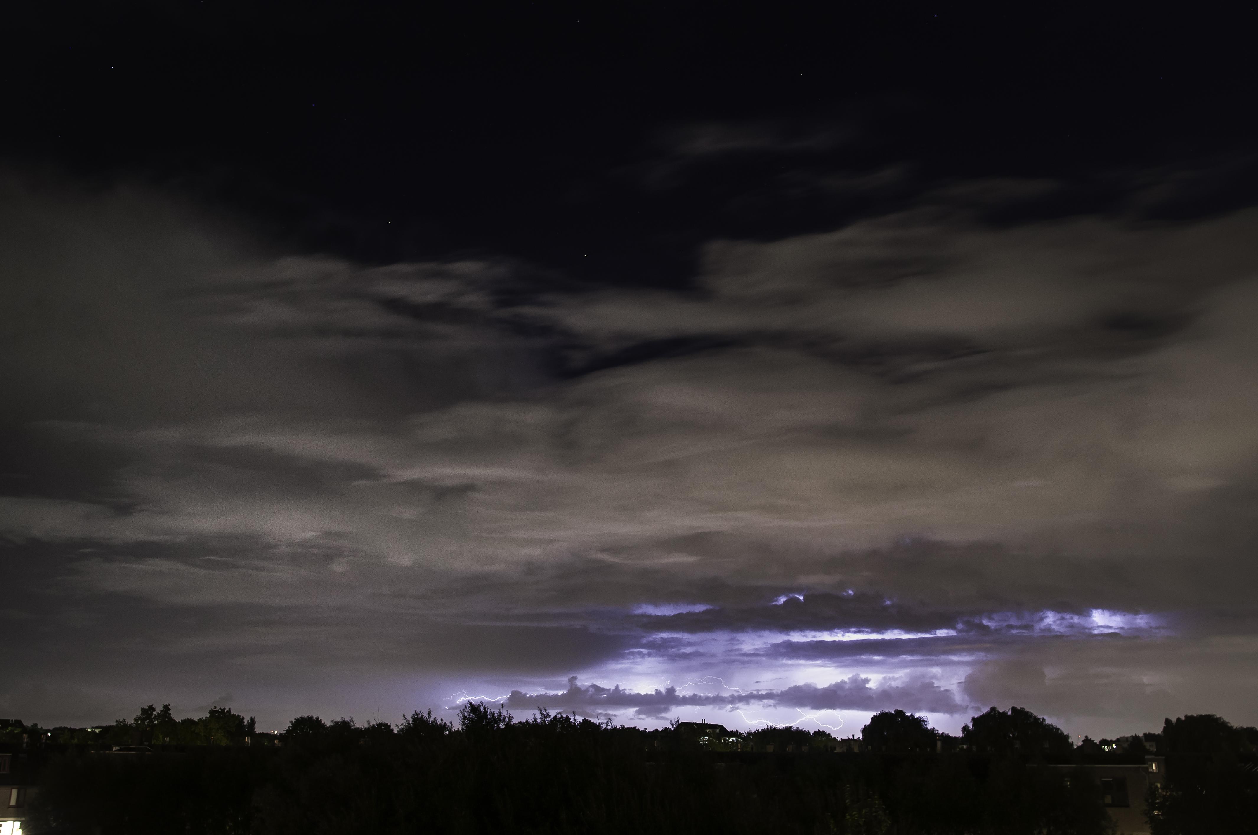 The stars above clouds full of lightning r/pics