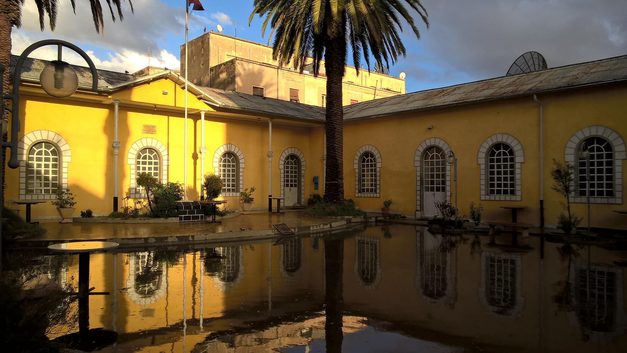Casa degli Italiani, Asmara, Eritrea Yellow house near body of water