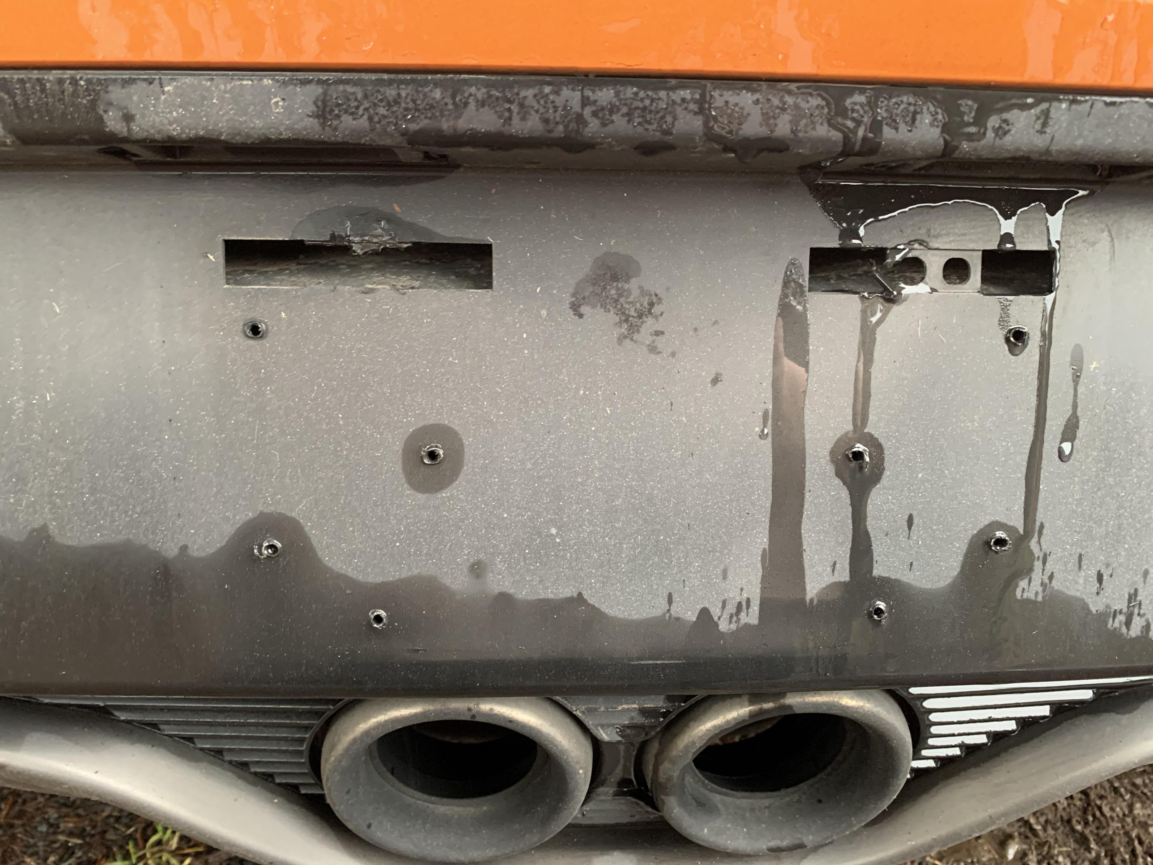 How to mount rear license plate? I noticed the little broken bits