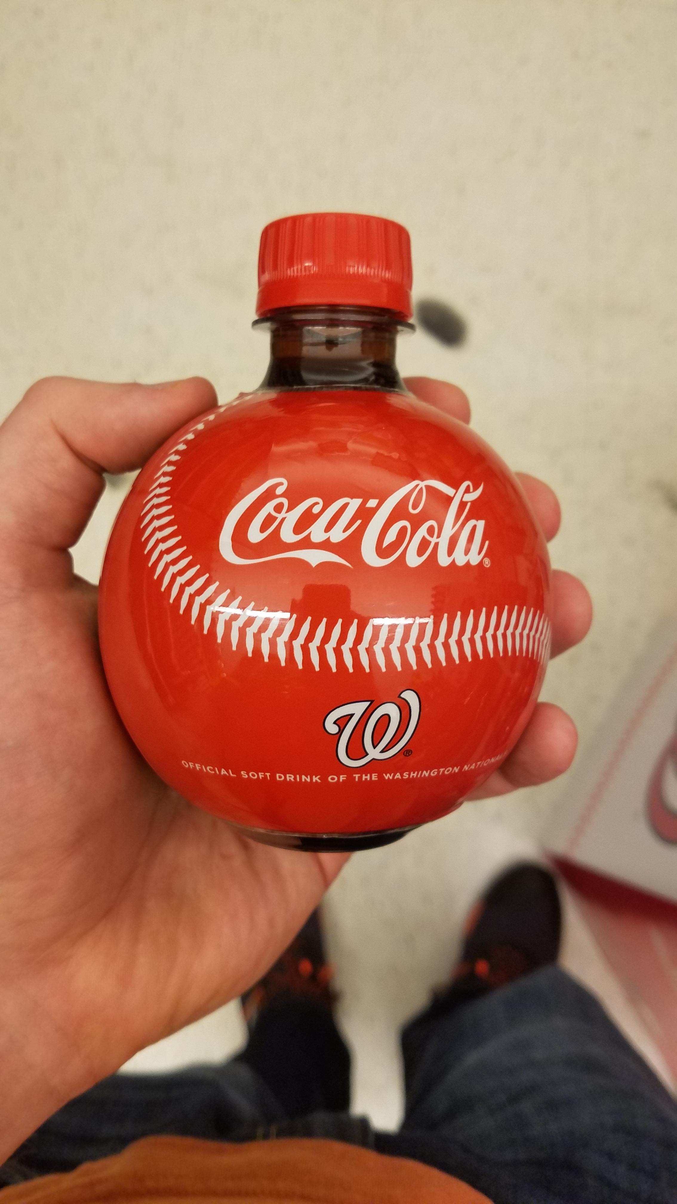 This bottle of coke is shaped and designed to look like a baseball