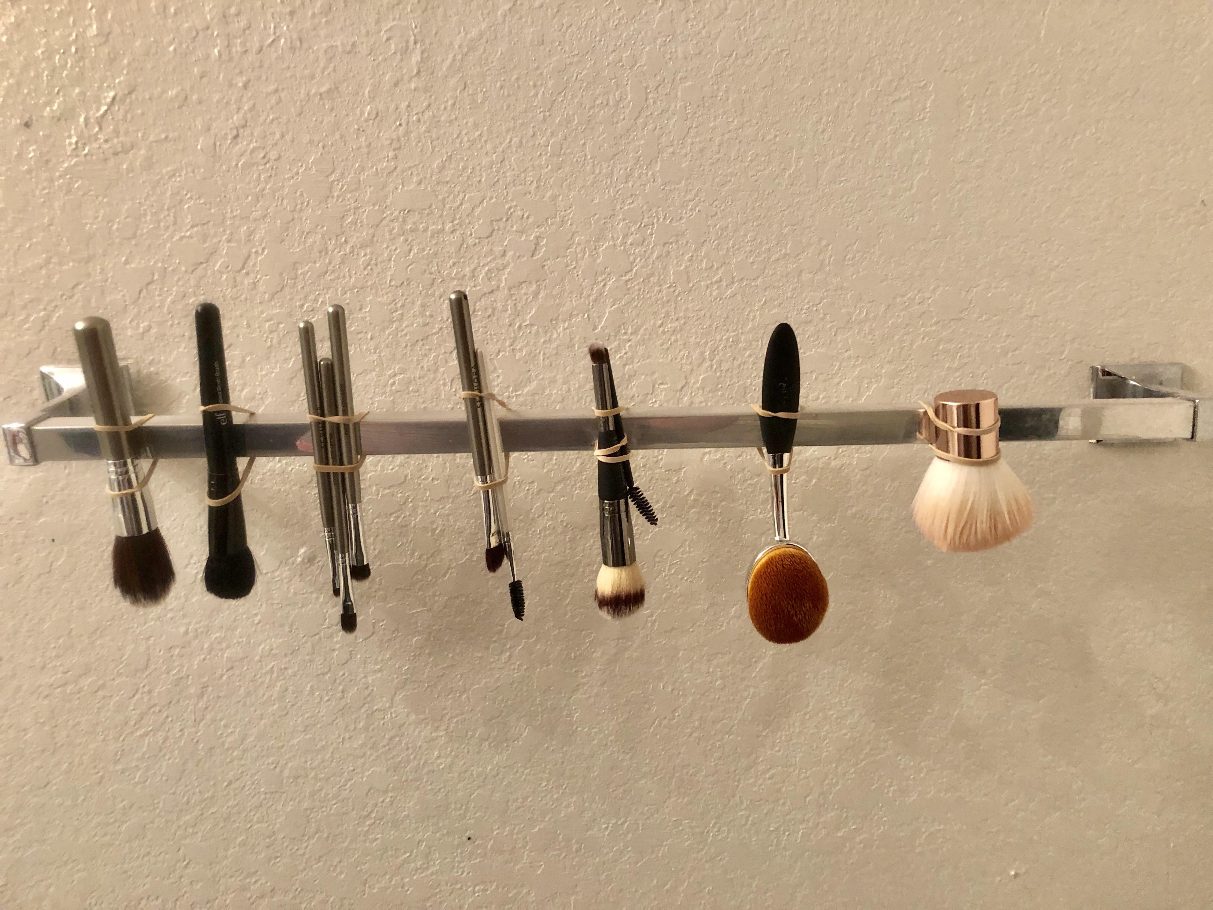 The best way to dry freshly cleaned makeup brushes. Hang upside down and the water doesn’t sit