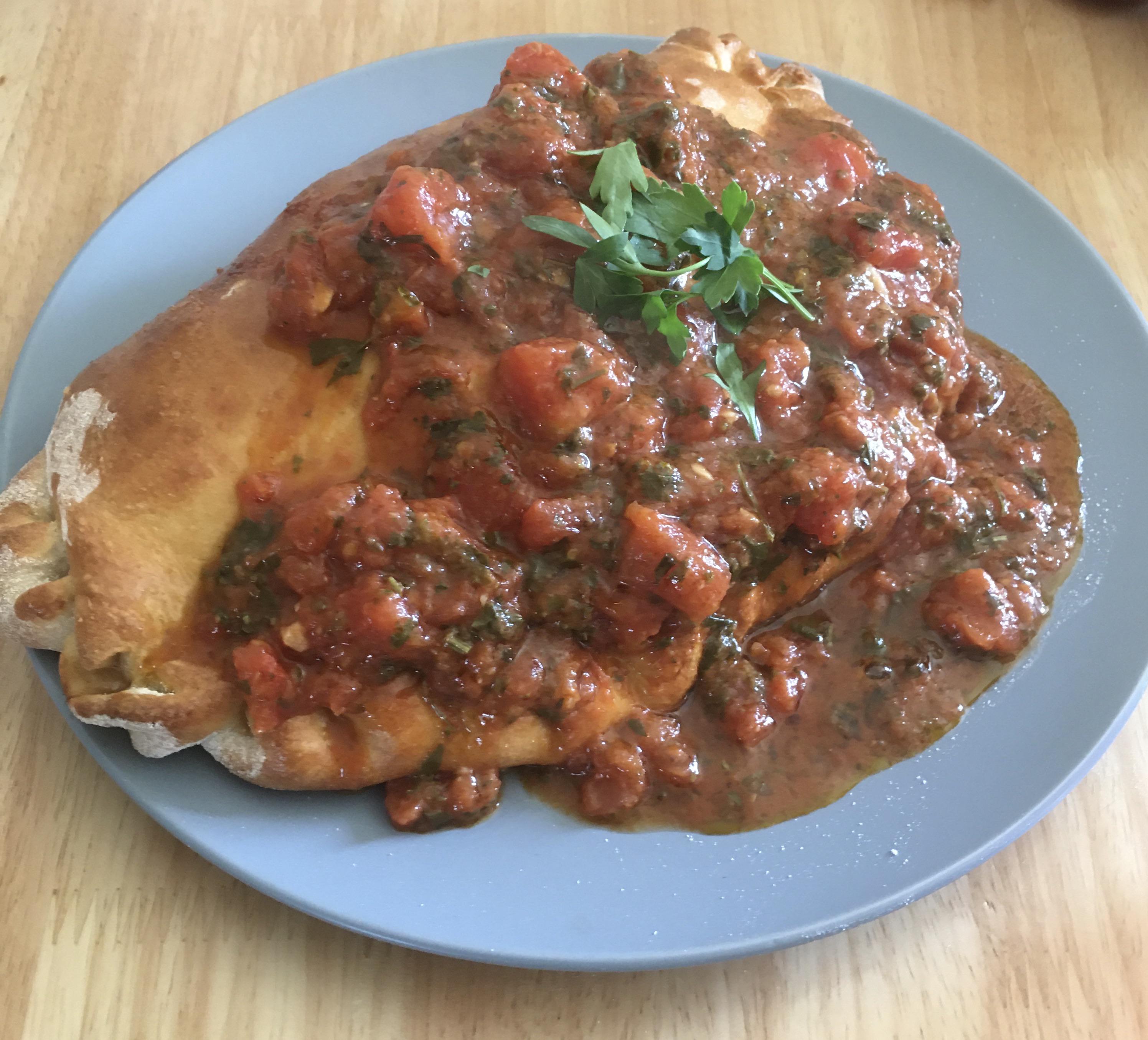 Homemade Kiev calzone filled with chicken, garlic, mushrooms and mozzarella cheese. Then