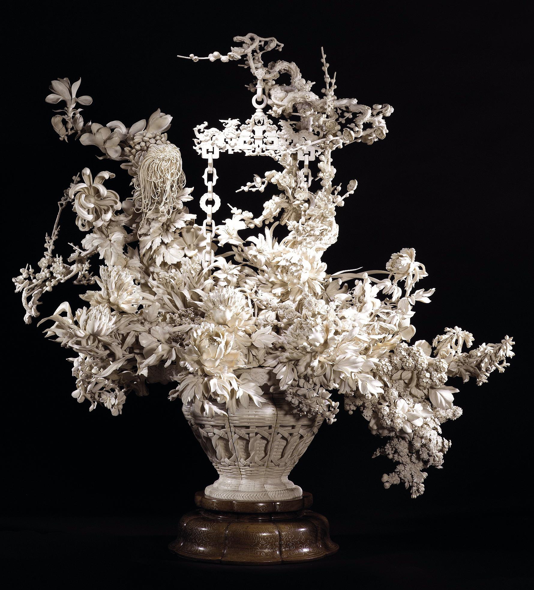 A Japanese intricate ivory sculpture of a basket of flowers. Meiji