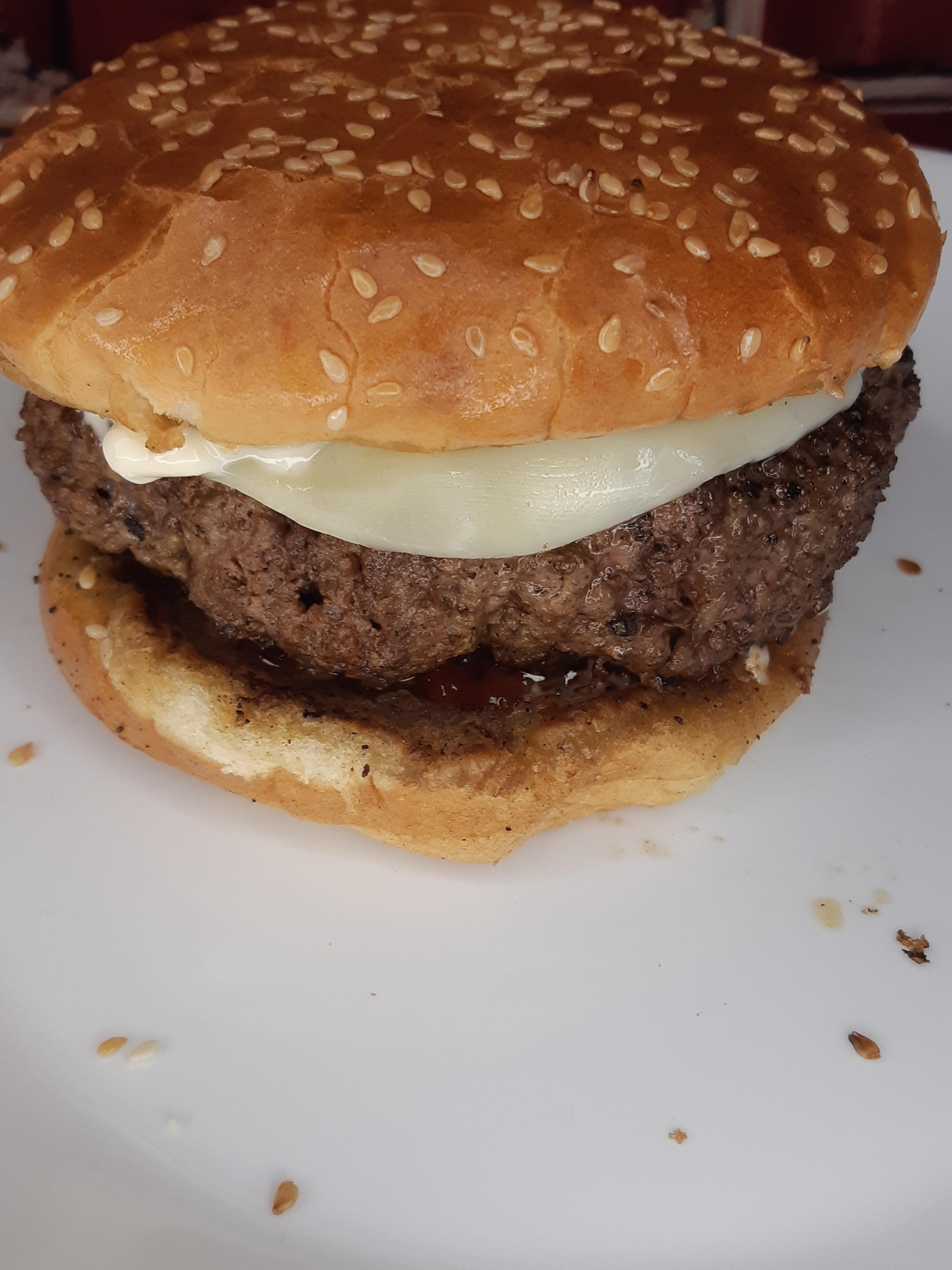 Cast iron burger w/ provolone & toasted bun. r/CastIronCooking