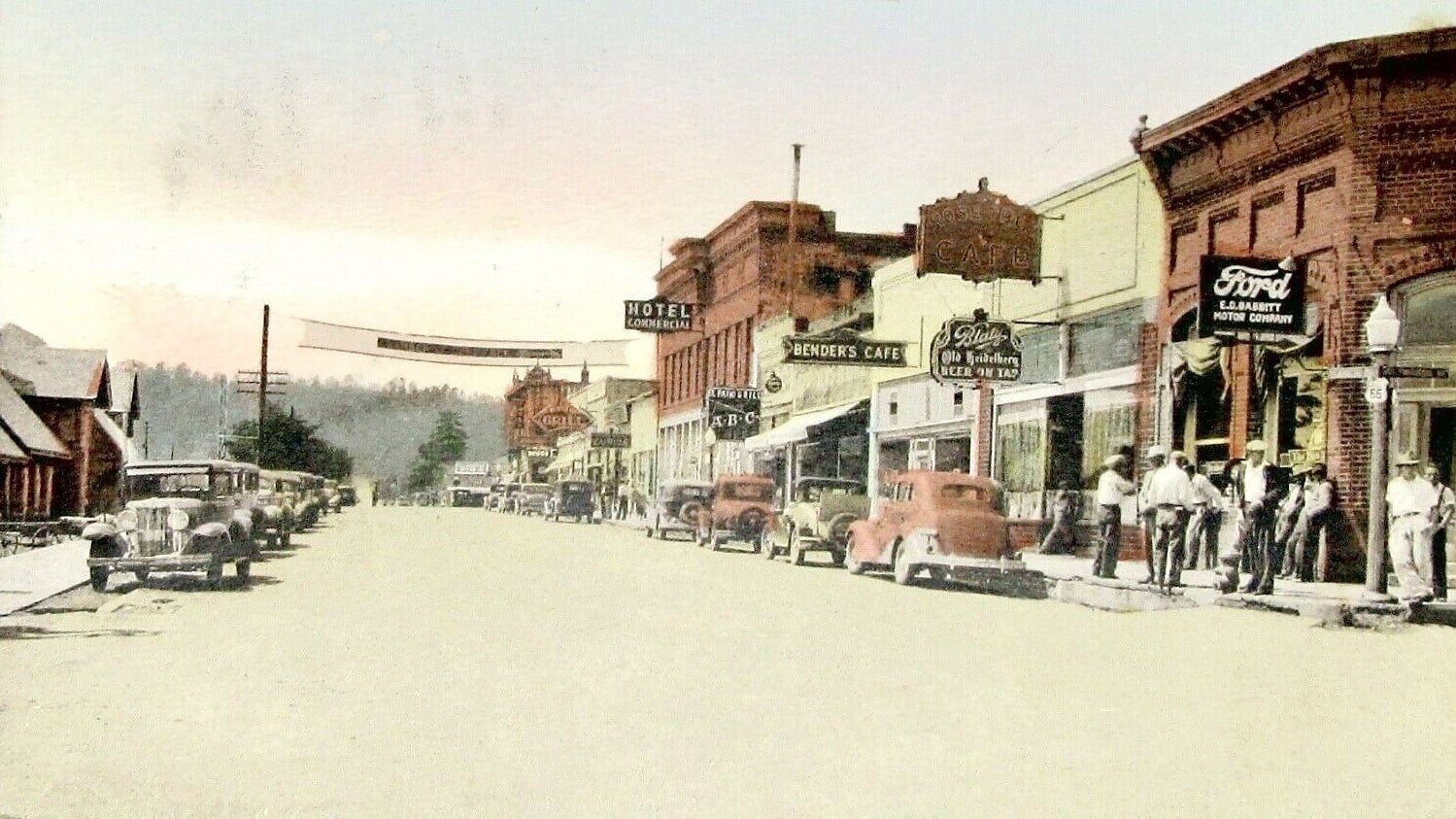 An early handcolored postcard showing downtown Flagstaff looking west