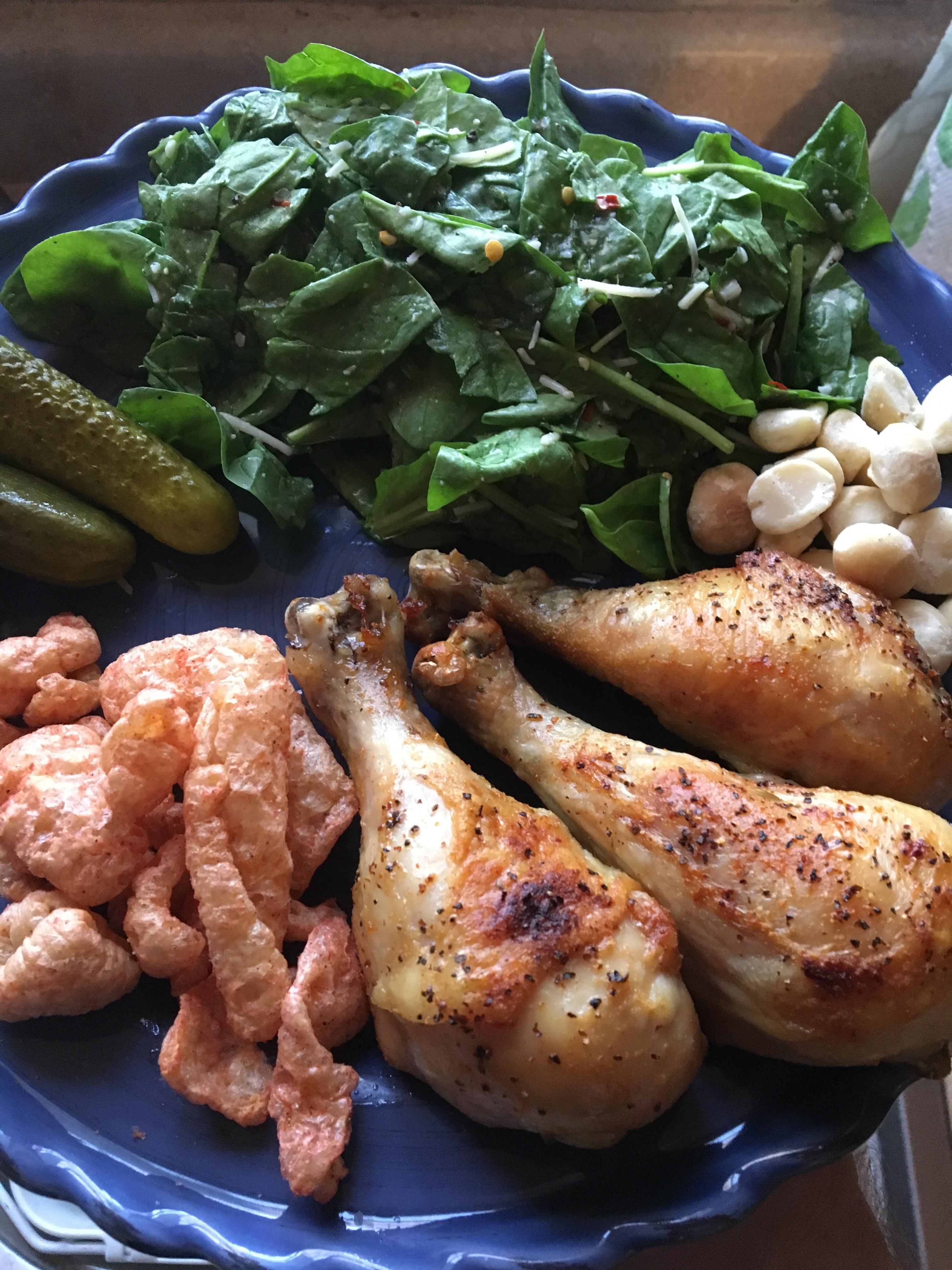 Roasted chicken drumsticks, spinach salad, spicy pork rinds, macadamia