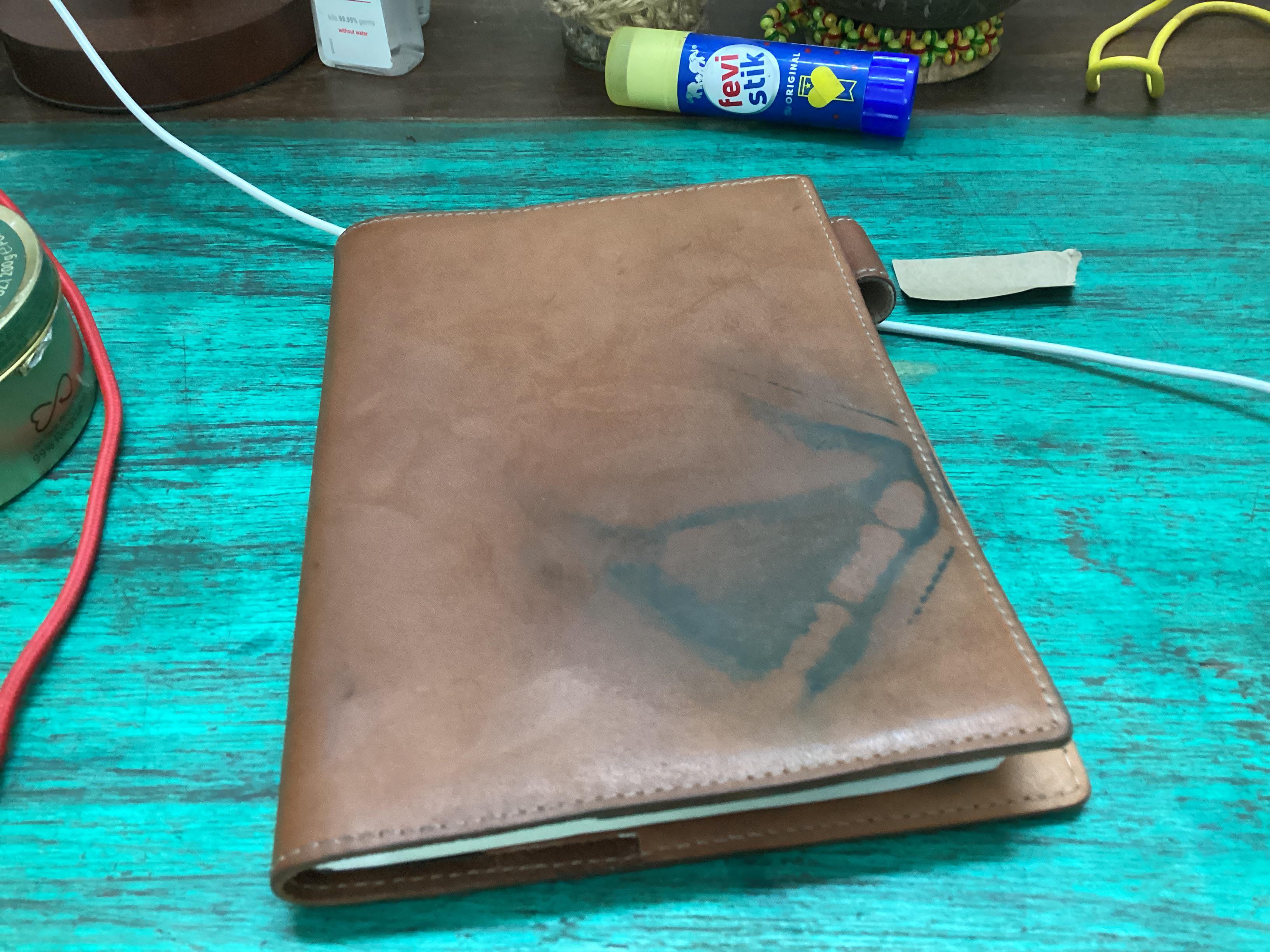 My poor beautiful undyed Galen leather notebook cover. Story of a