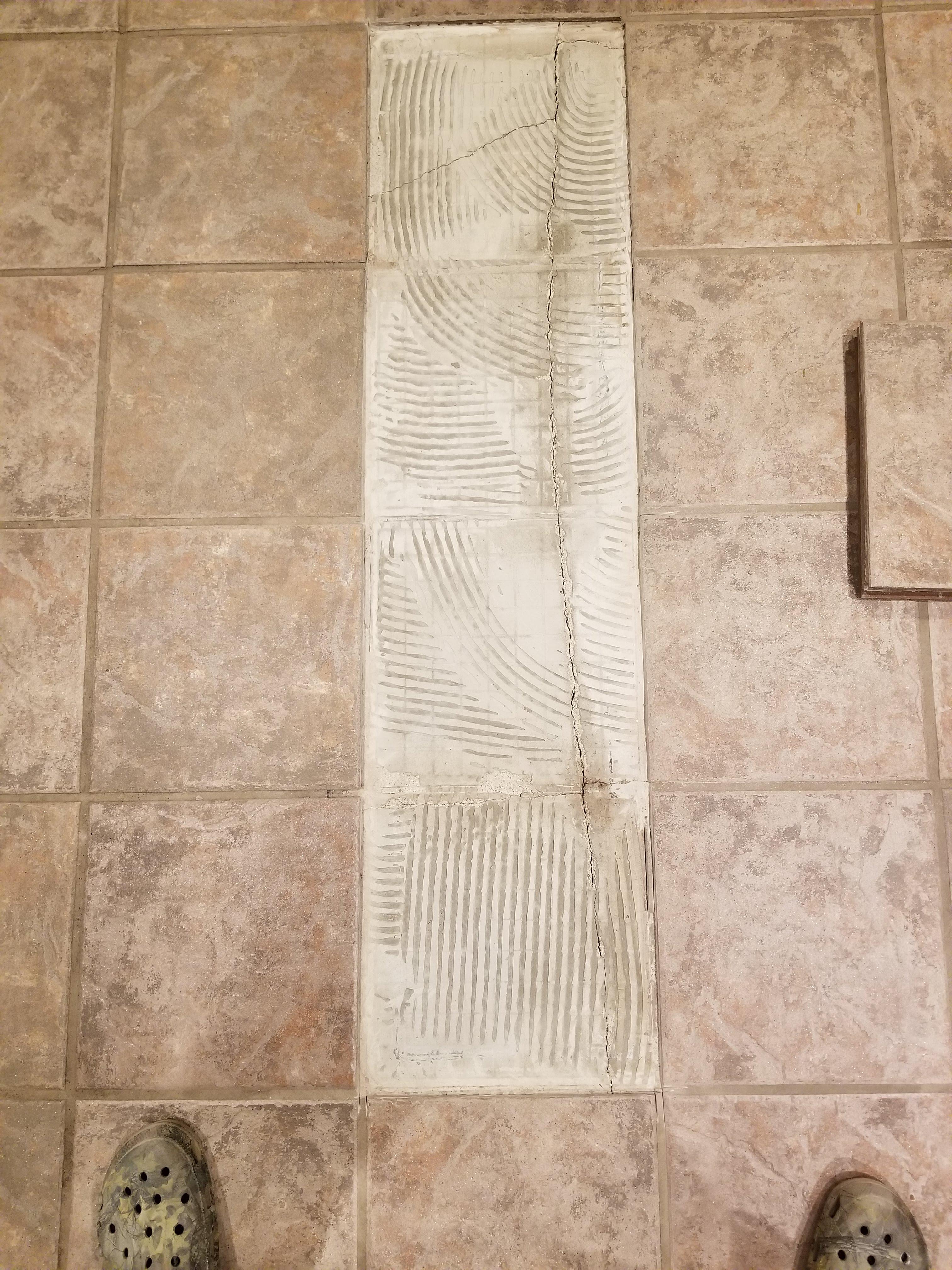 Wanted to fix loose tiles and missing grout. Found this underneath. Suggestions on how to