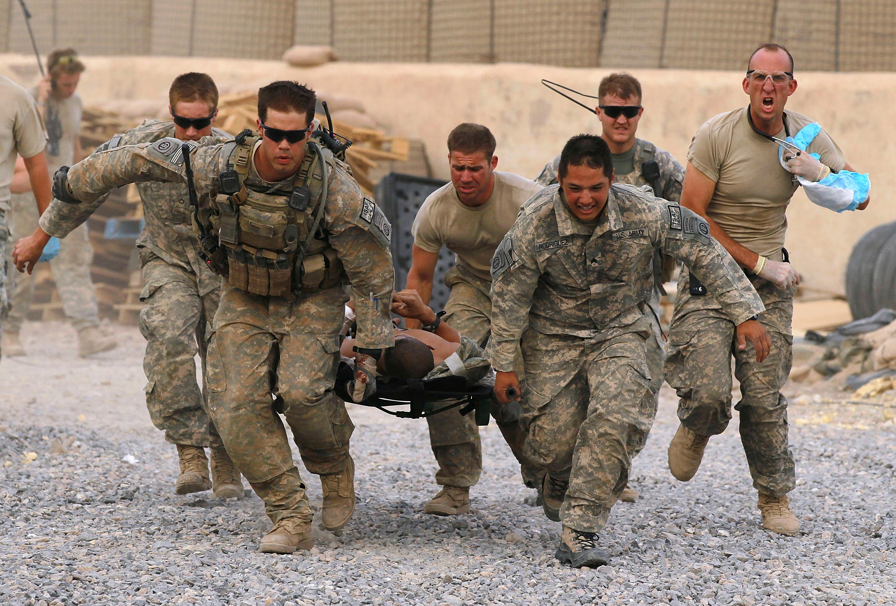 The 'Golden Hour'. US soldiers carry a critically wounded Teammate on a