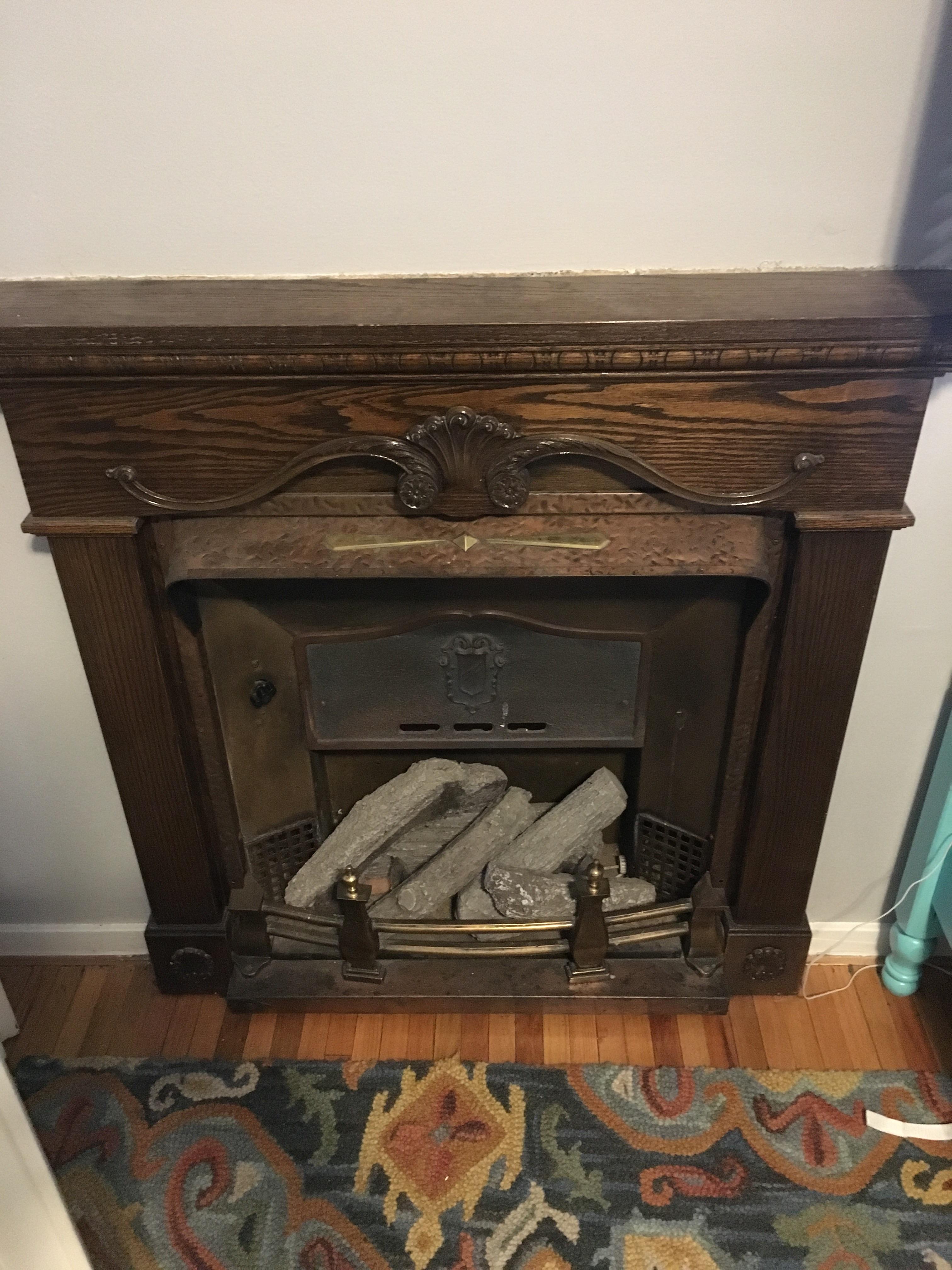 Trying to ID an antique electric fireplace with a metallic heat bar to