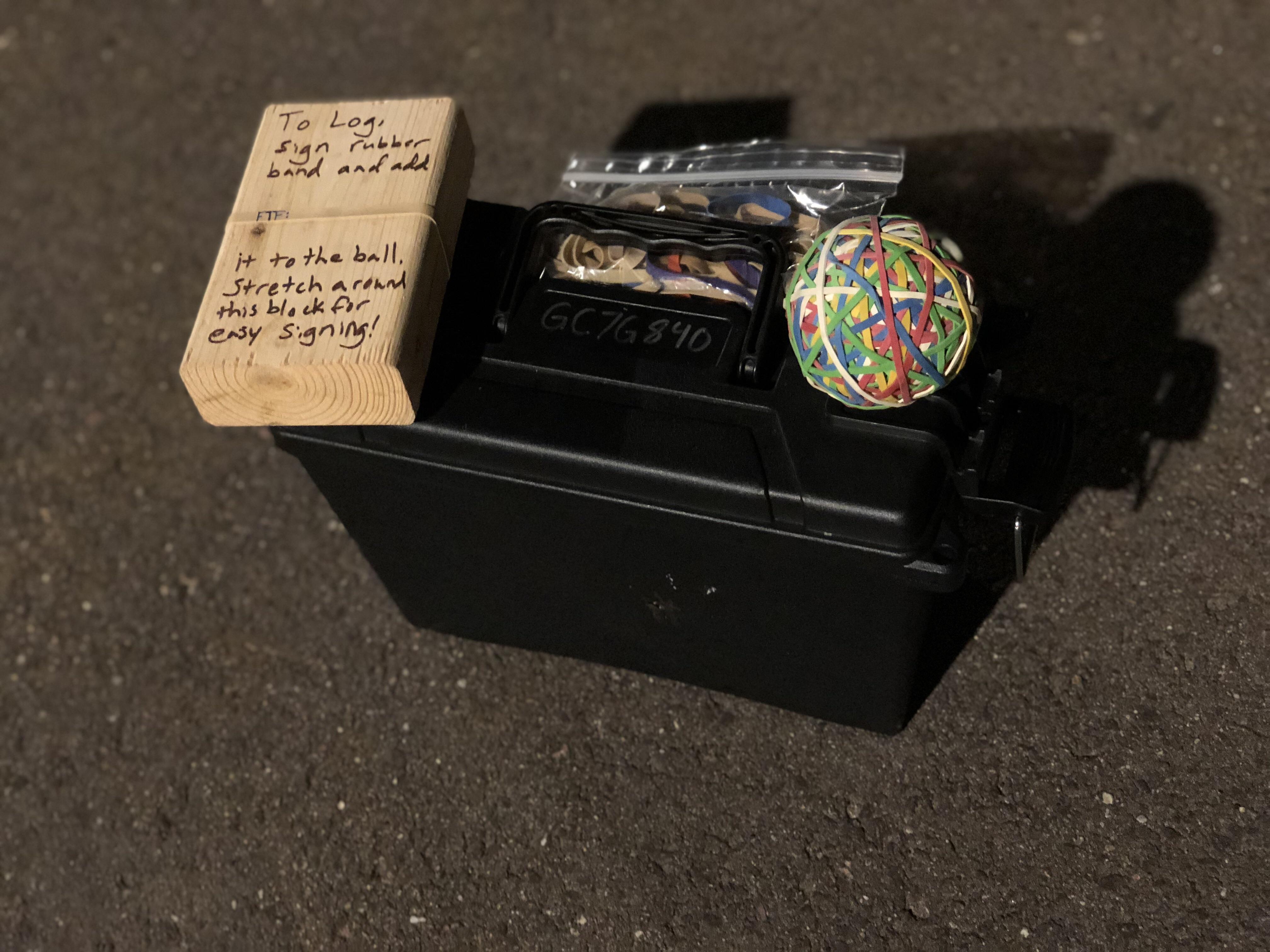 My newest cache... the log book is signing a rubber band and adding it