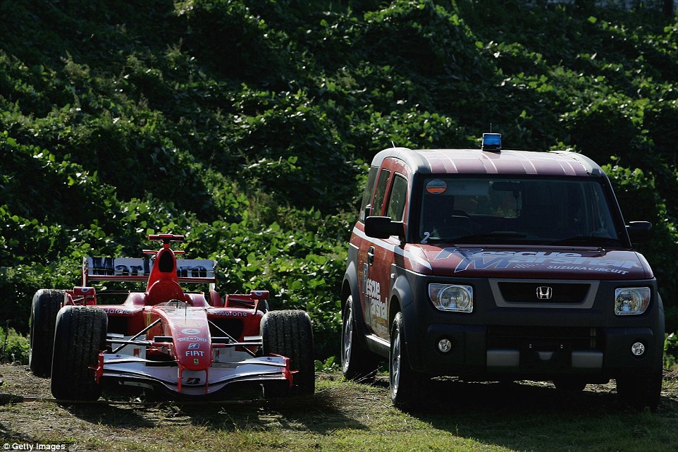 Michael Schumacher's stricken Ferrari at the side of the road during