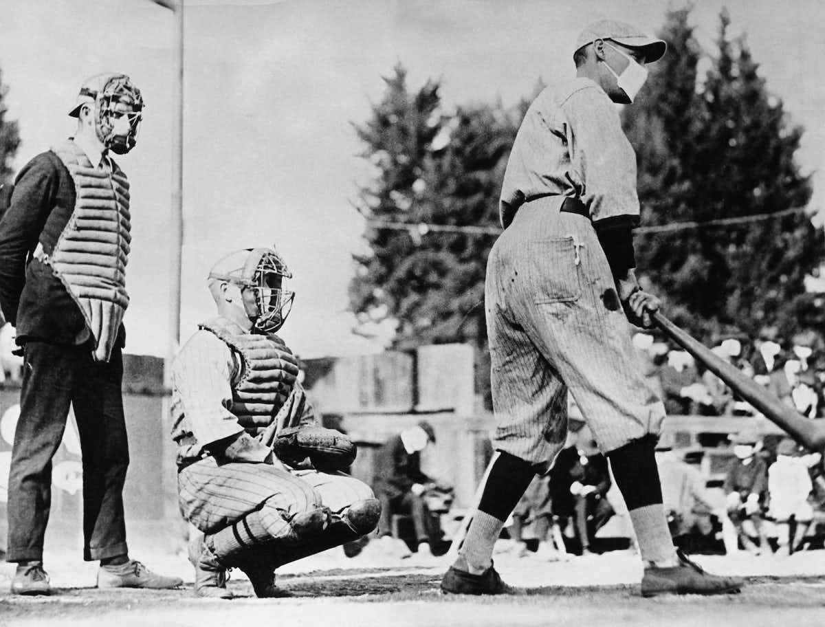 A baseball player dons a mask during the Spanish flu (1918) r