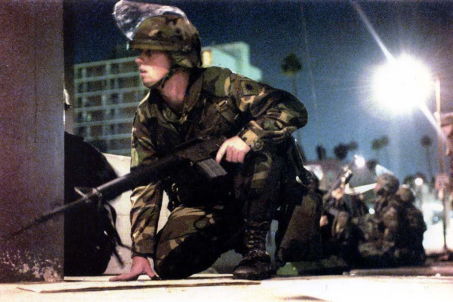 A California National Guard soldier ducks along with his fellow