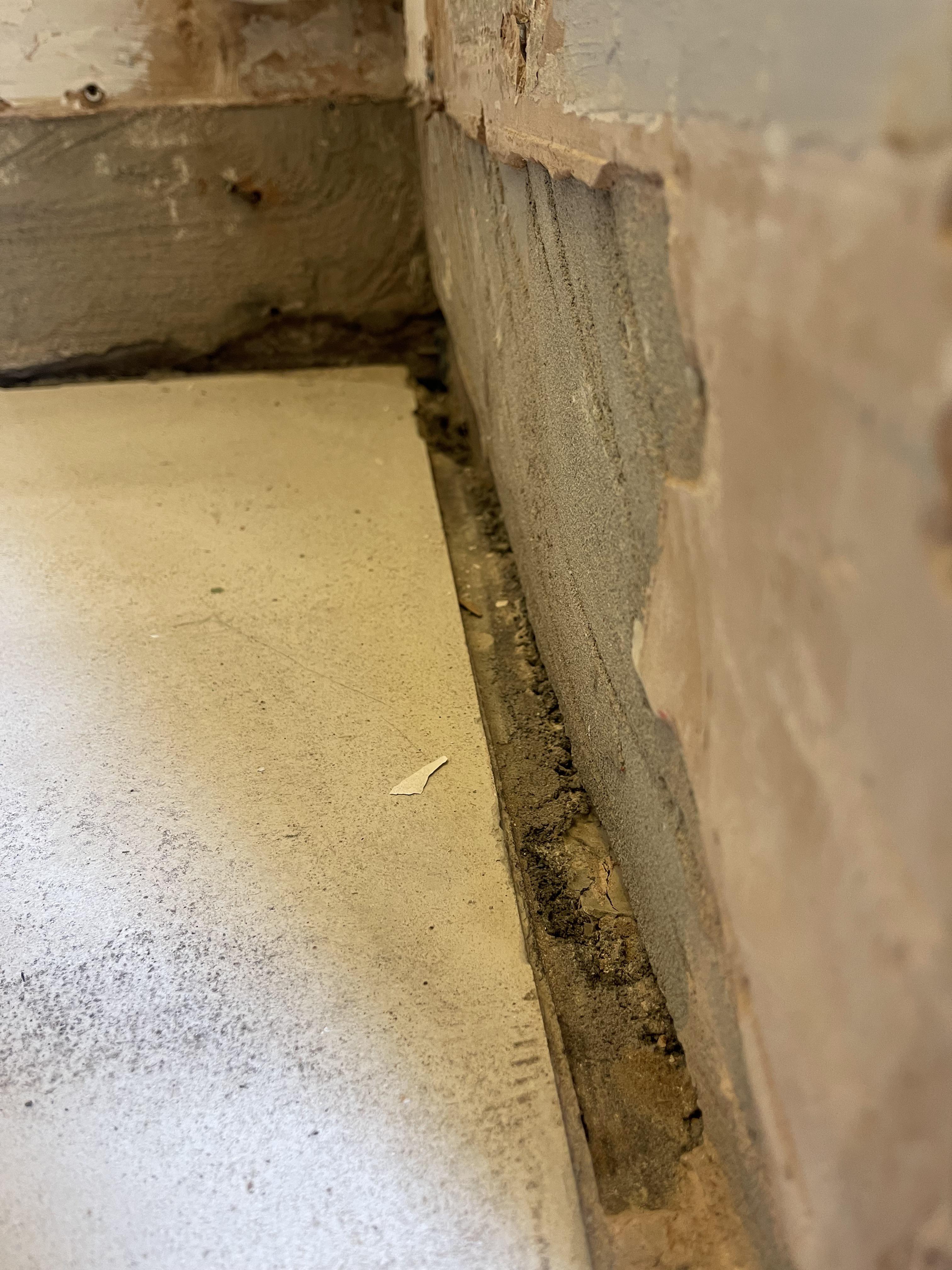 Should I fill the gap between concrete floor and plaster/concrete wall