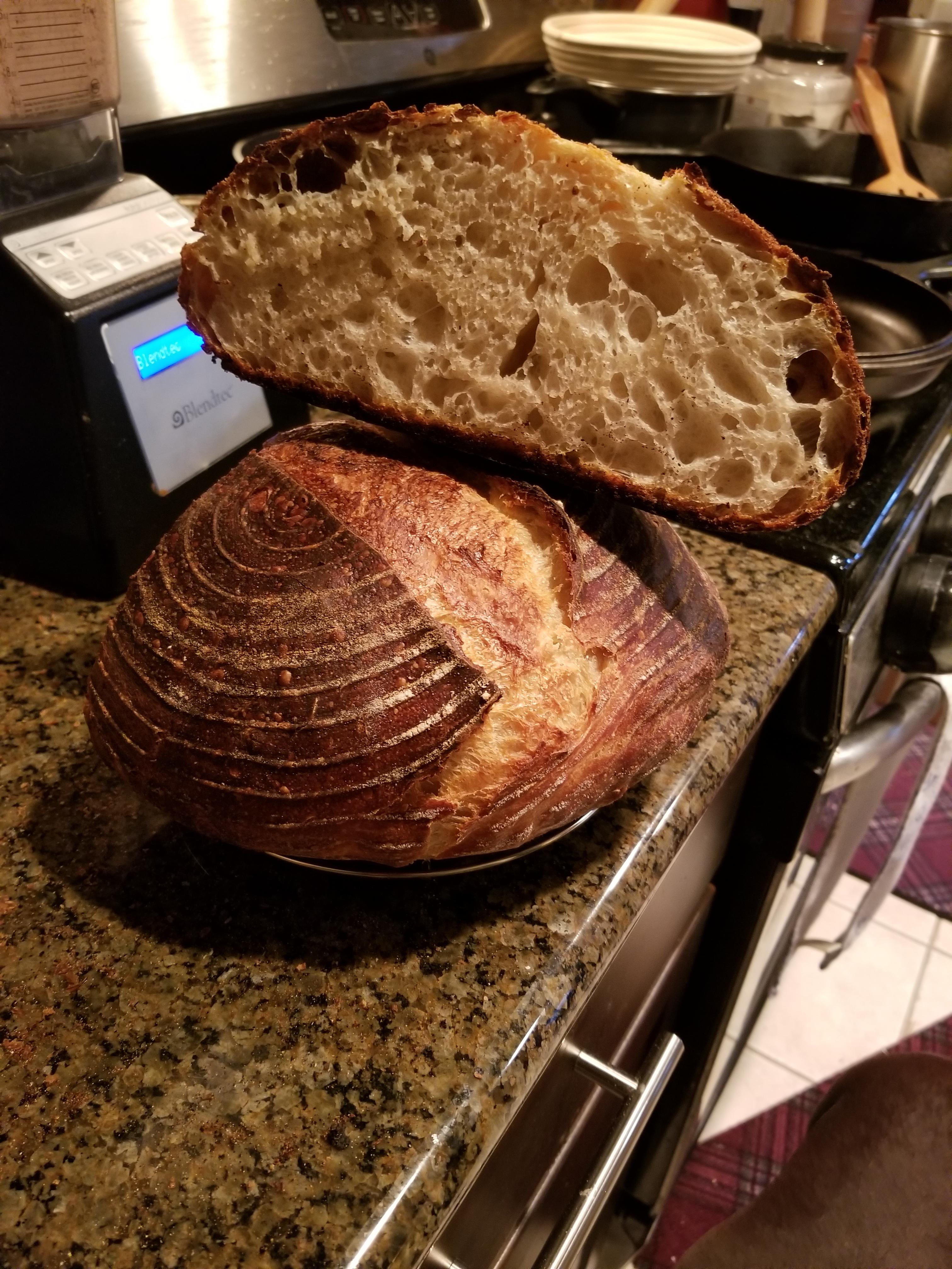 My first sourdough. Stuck to proofing basket and got a bit dark on