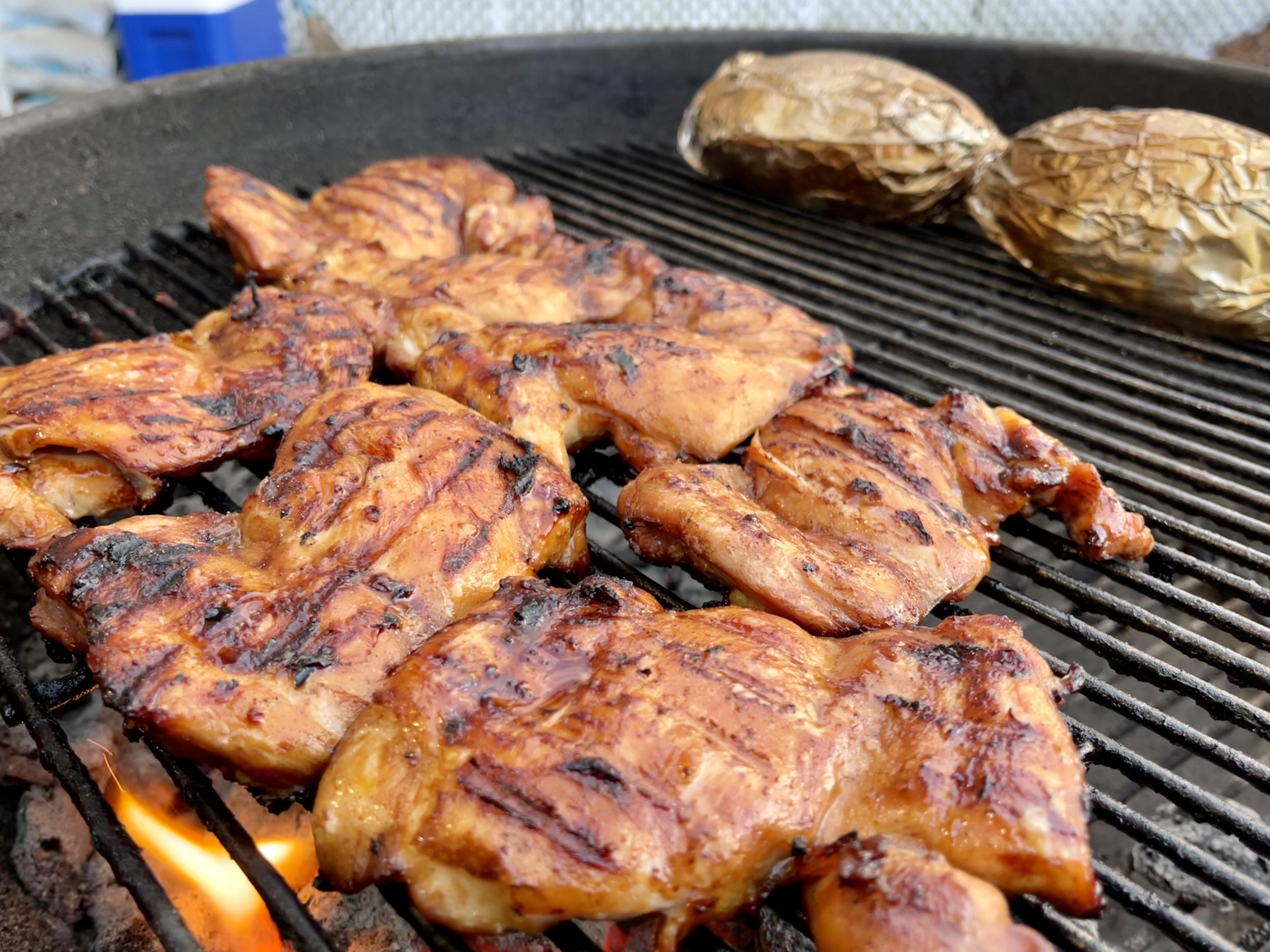Asian marinated chicken thighs over charcoal r/grilling