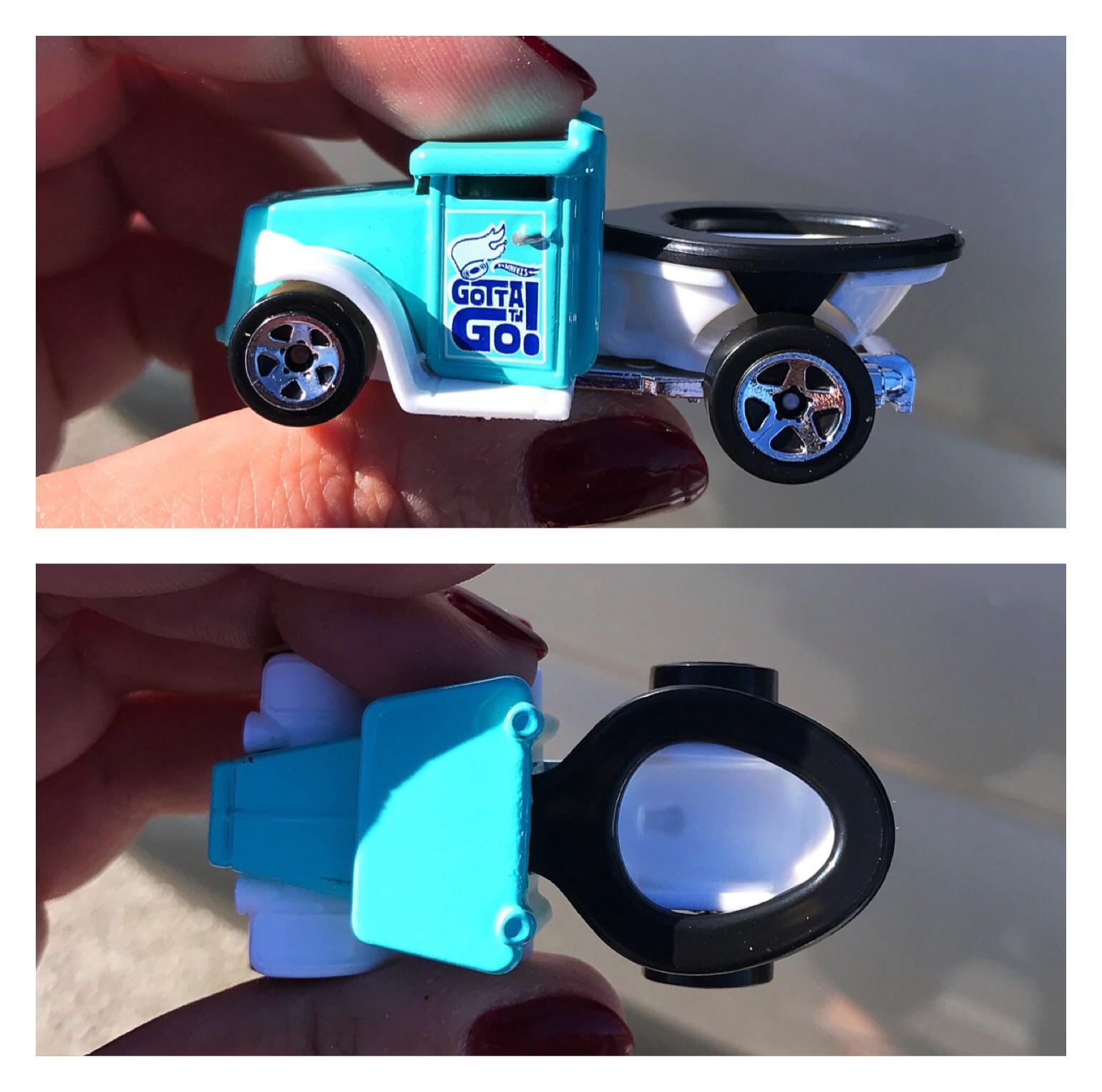 This Hot Wheels truck with a toilet bowl attached to the back. r