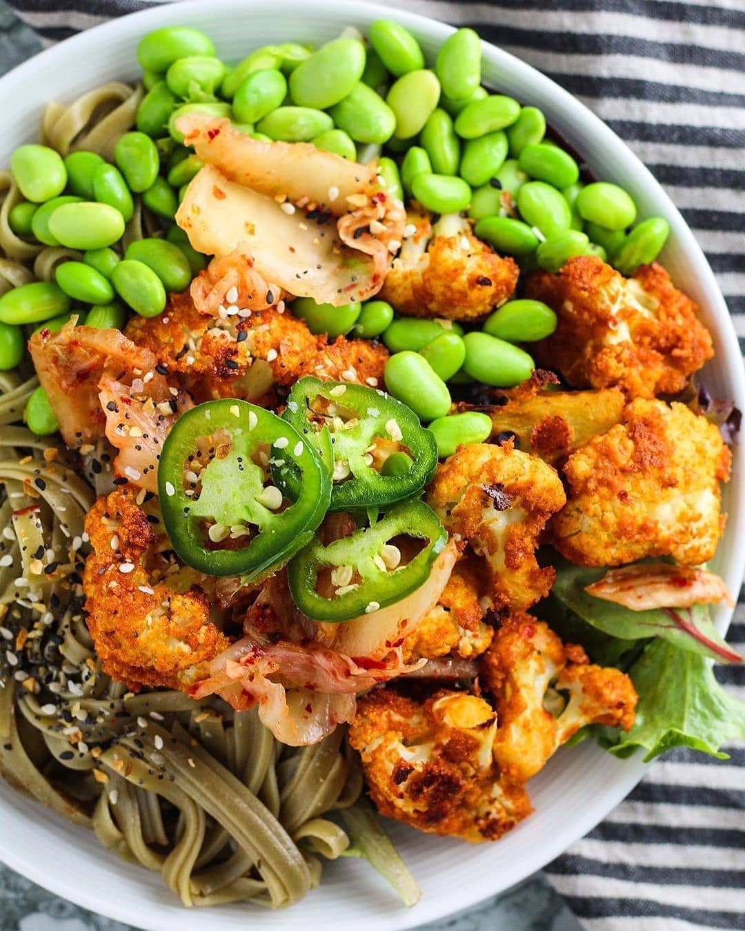 Delicious bowl Filled with Gochujang Spiced Cauliflower Bites, edamame