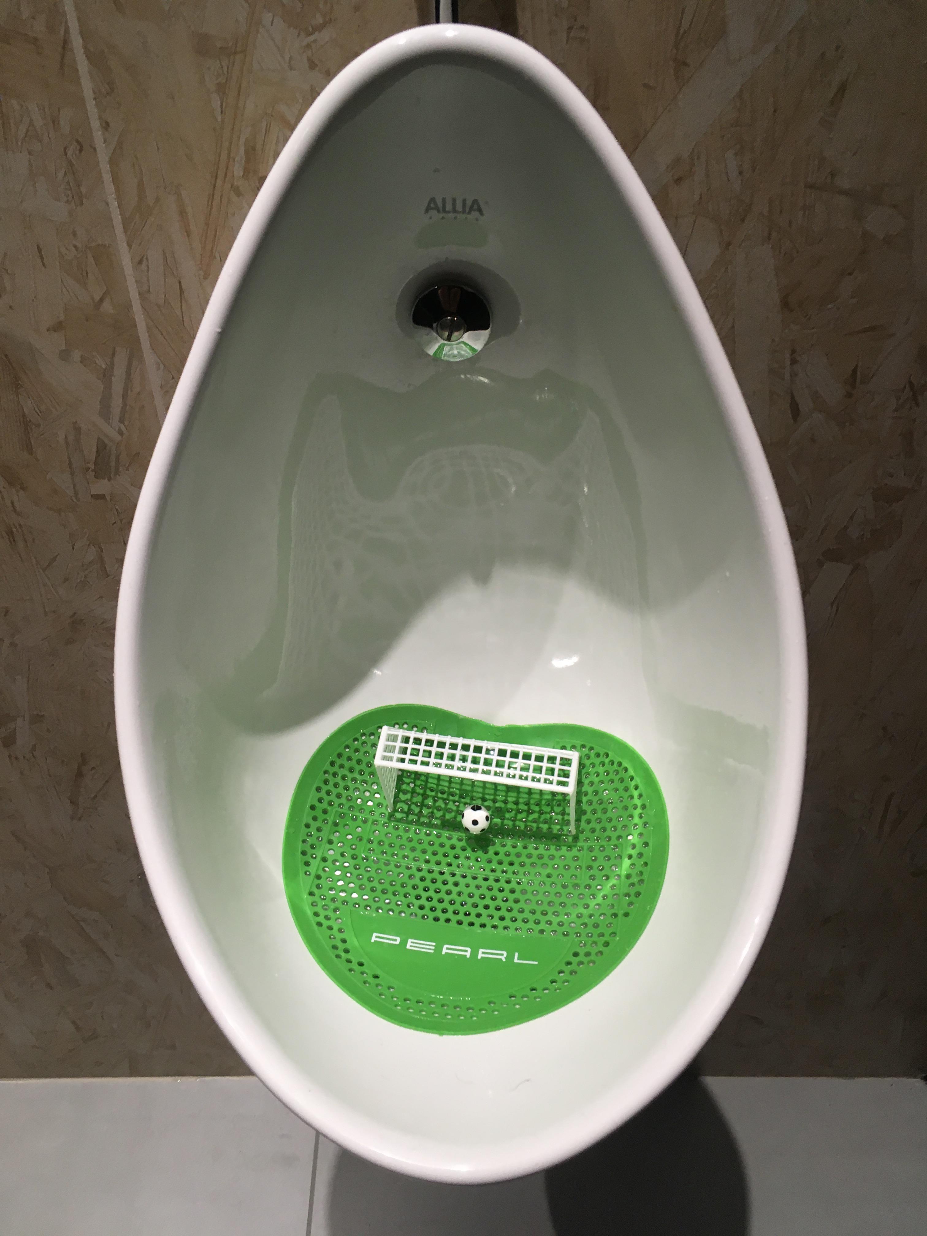 Urinal mat with a shape of soccer playground, cage and ball you can