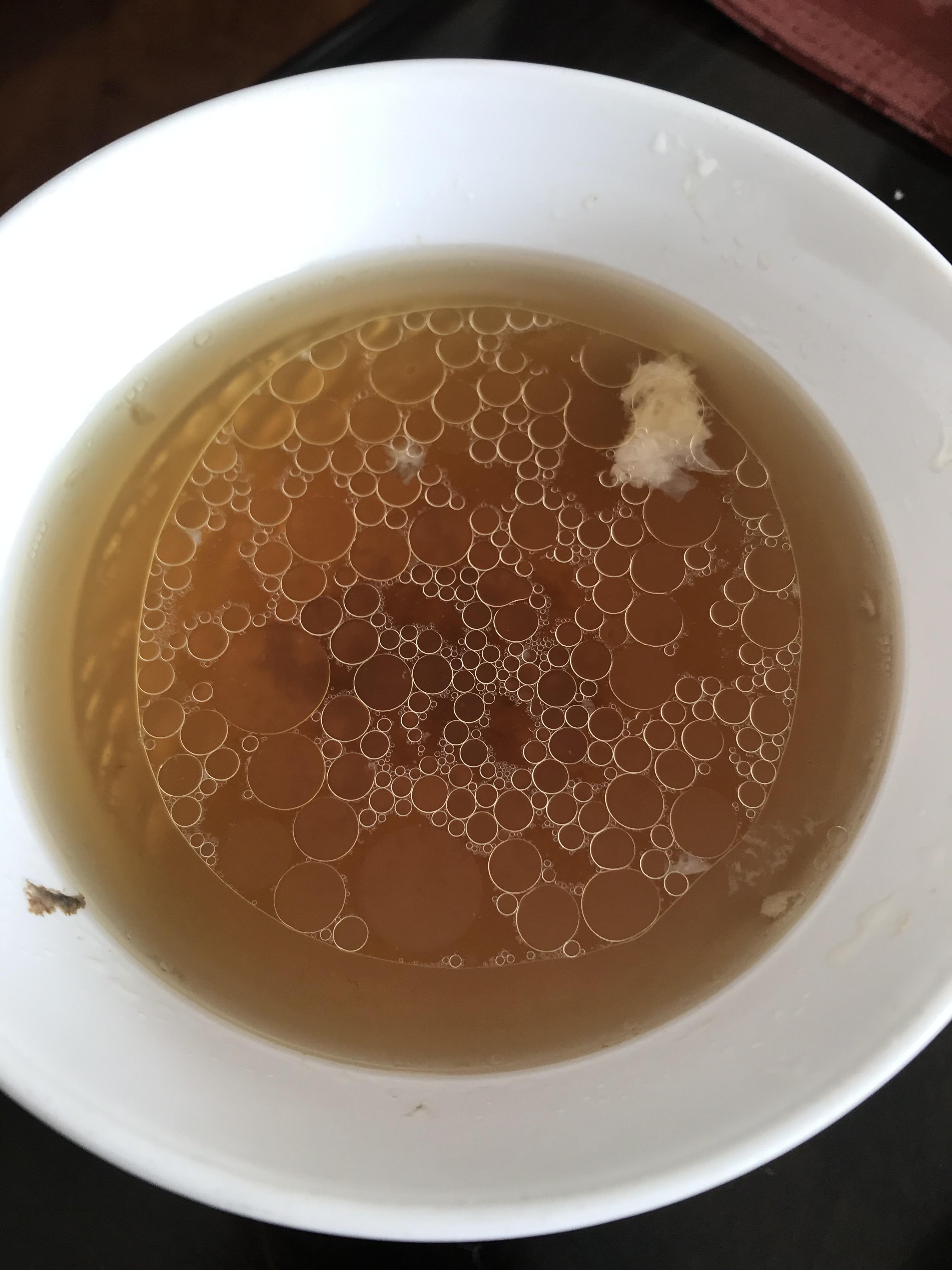 Chicken fat in soup settled and made a perfect circle out of other