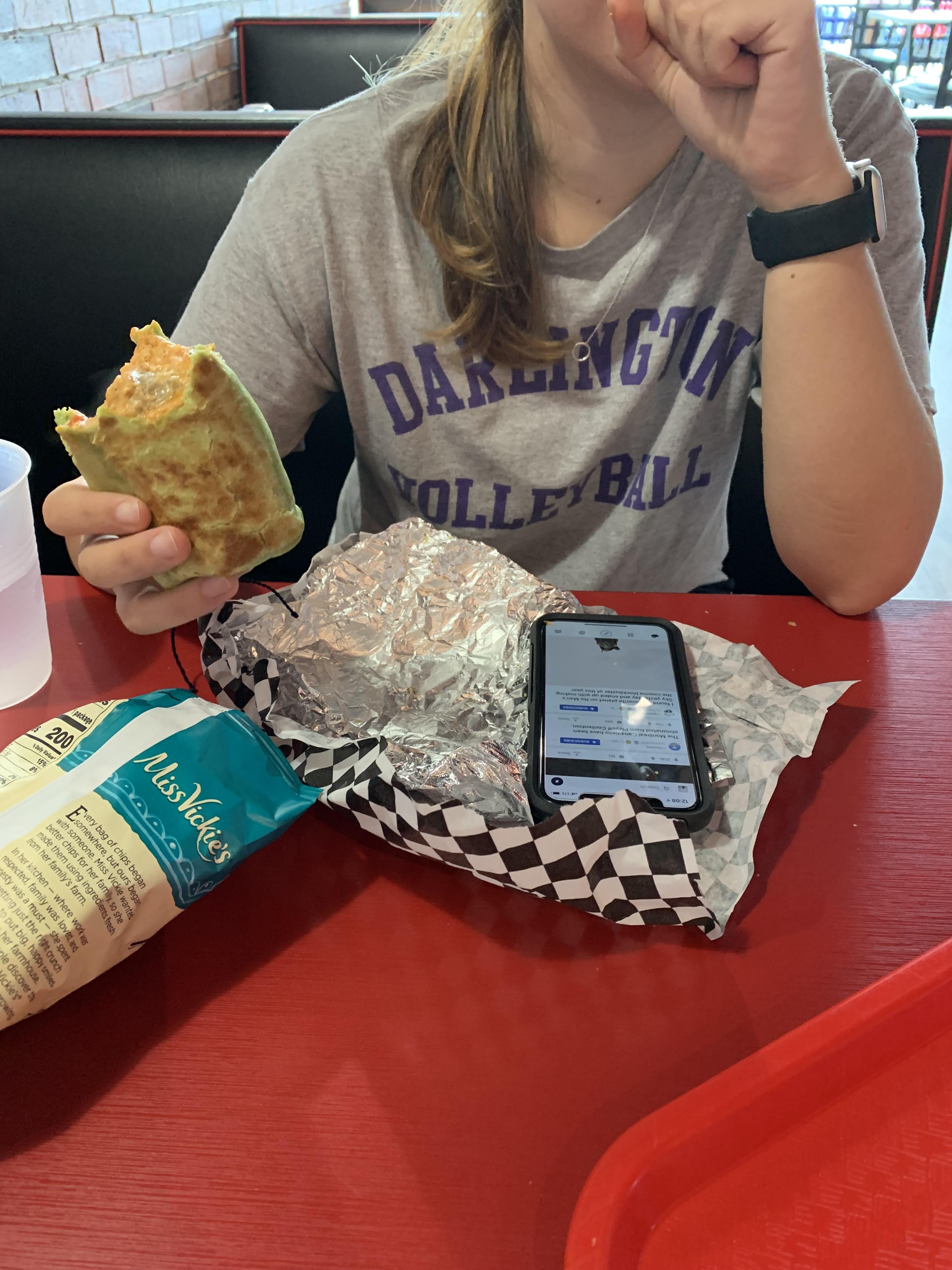 Sister eating over her phone while browsing reddit and dripping food