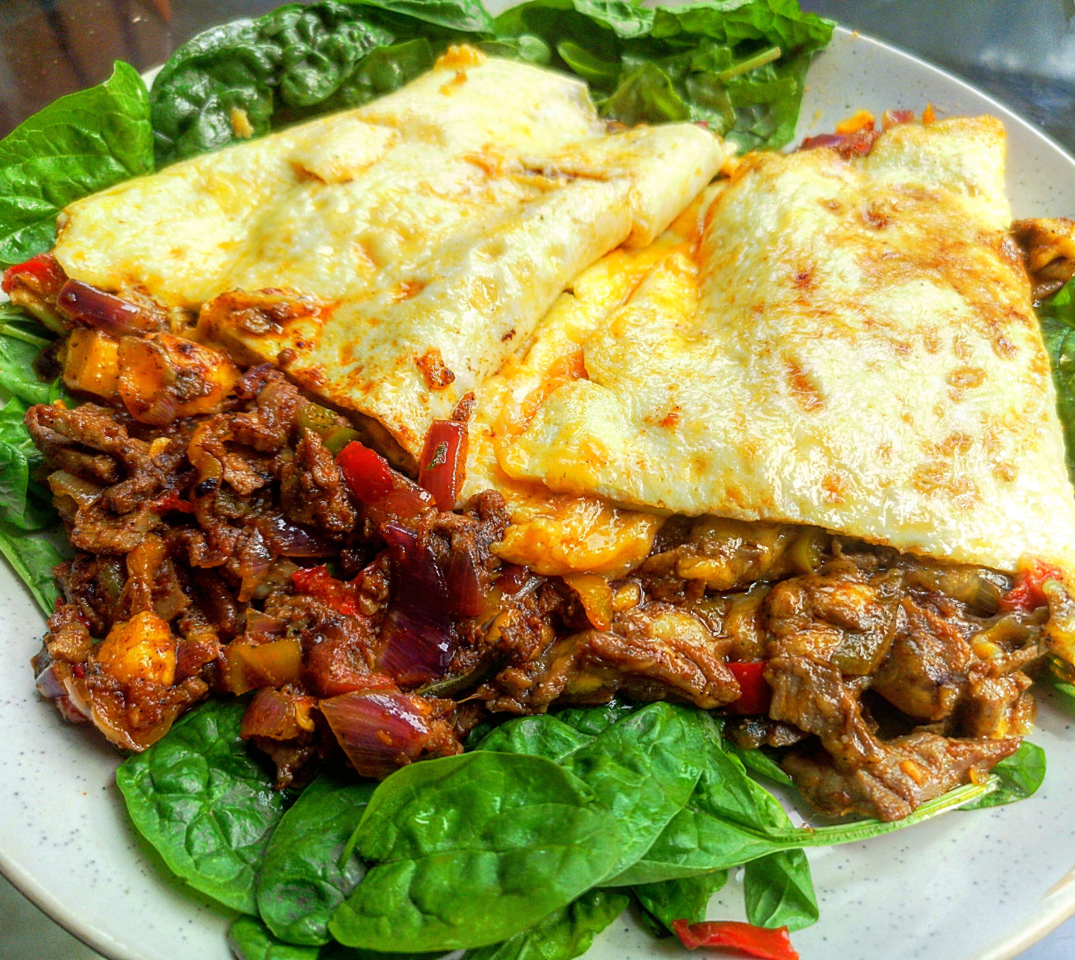 A delightfully greasy cheese steak omelette, which was that big I had to cut it in half to fit