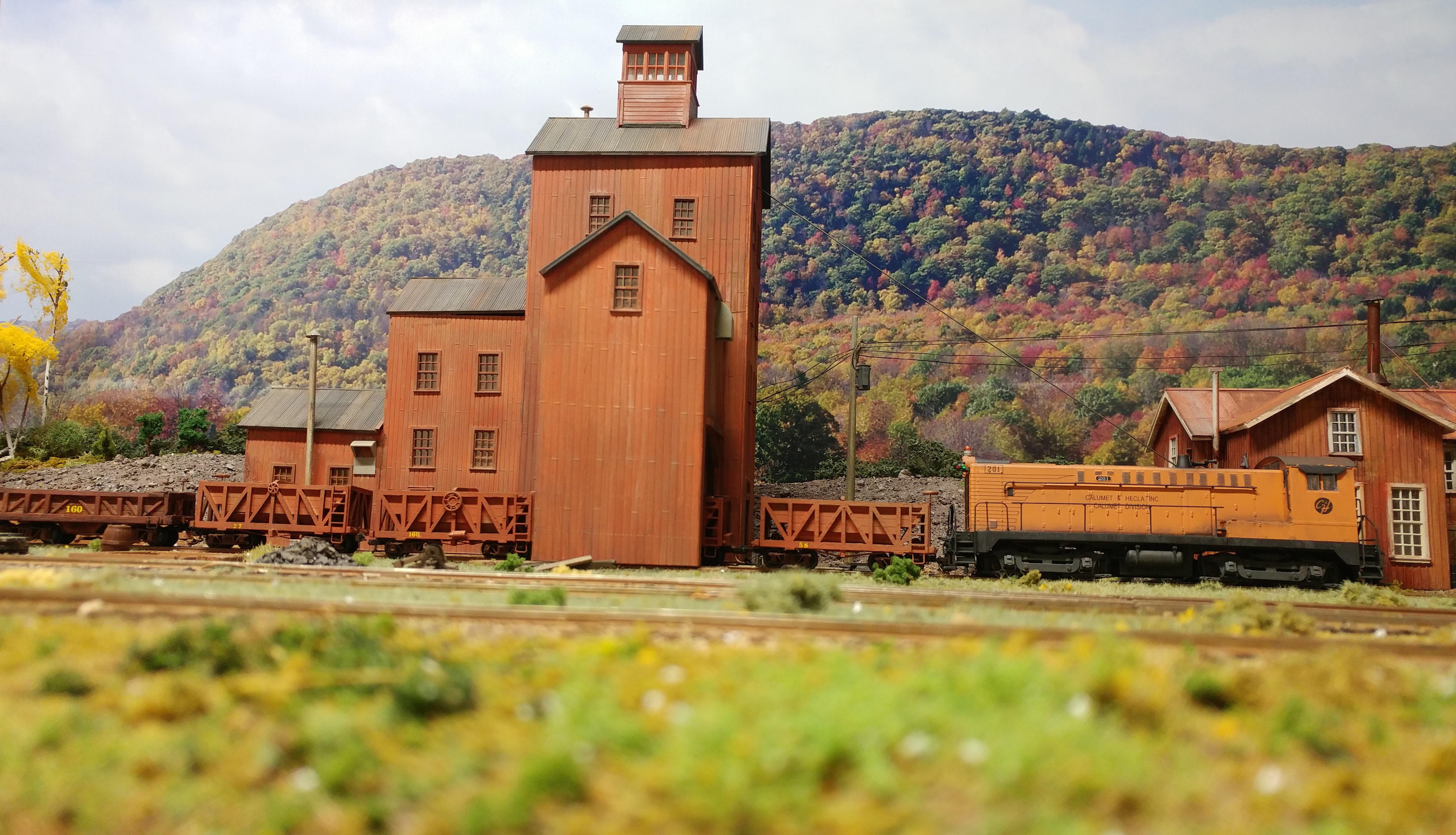 Calumet & Hecla Mining 201 moves wood ore cars for loading under the